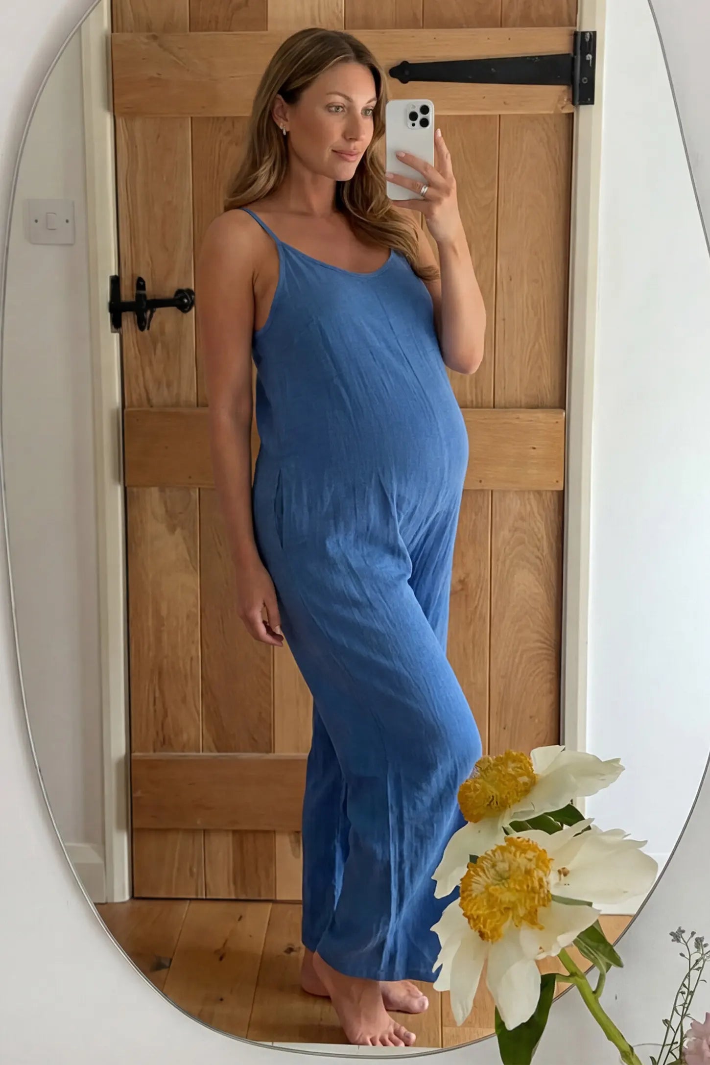 Wide‑Leg Scoop Neck Pocketed Maternity Jumpsuit Wide-leg scoop neck pocketed maternity jumpsuit in blue with sleeveless design, thin strap, and wide-leg silhouette, UGC model
