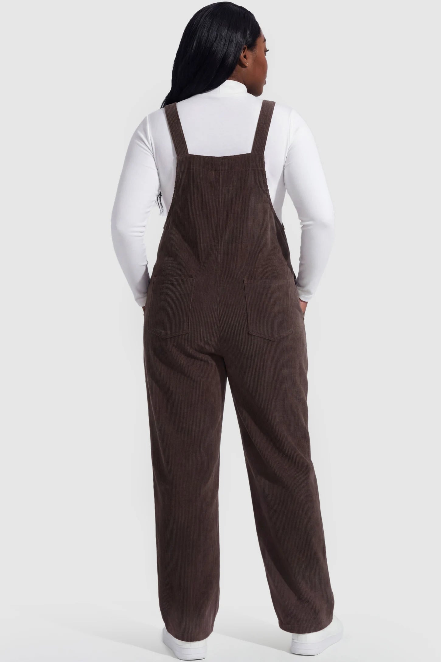 Wide Leg Side Stretch Panel Maternity Overalls Wide leg side stretch panel maternity overalls in brown featuring flexible side panels on a pregnant model