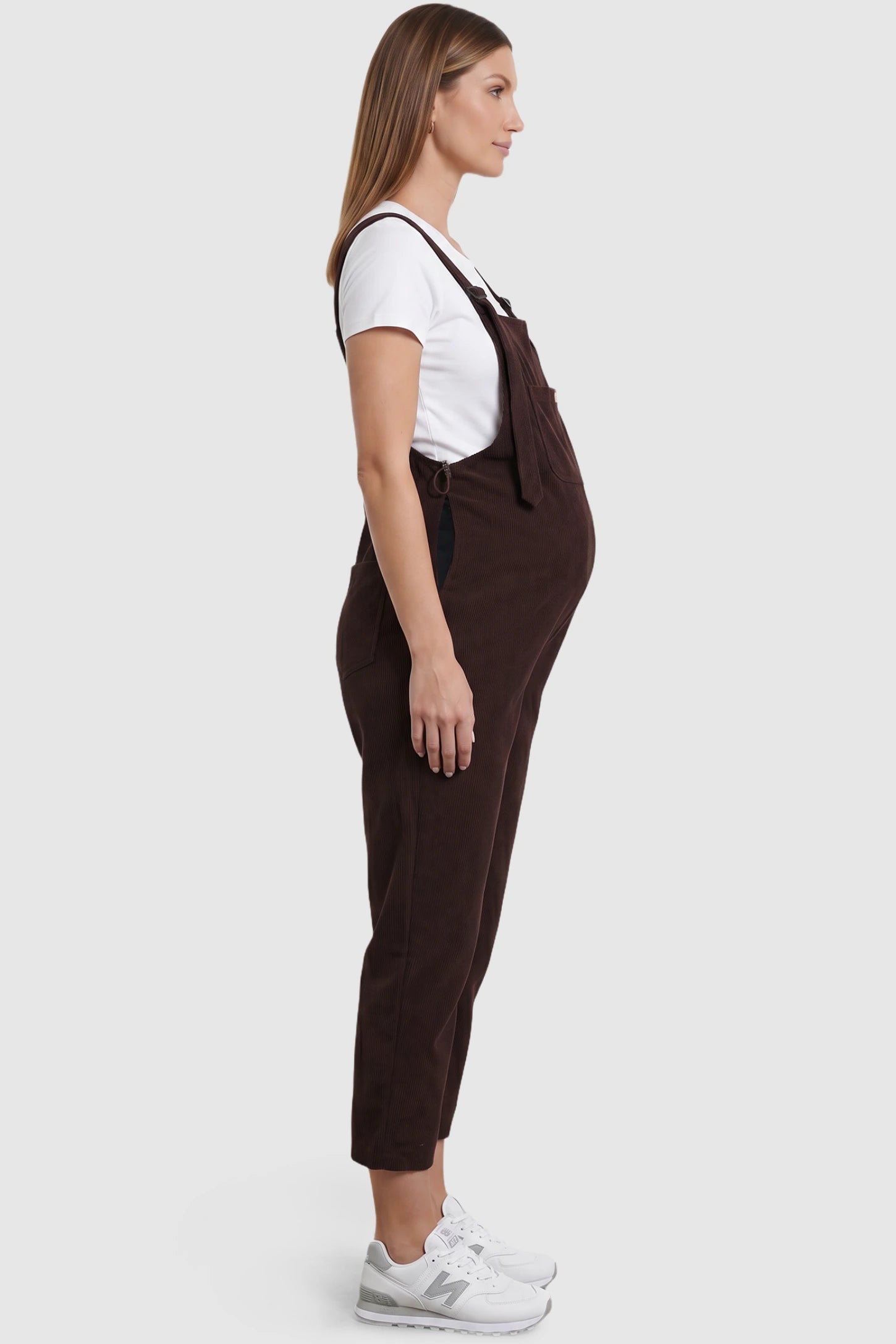 Wide Leg Side Stretch Panel Maternity Overalls Wide leg side stretch panel maternity overalls in brown with soft corduroy texture, side view on pregnant model