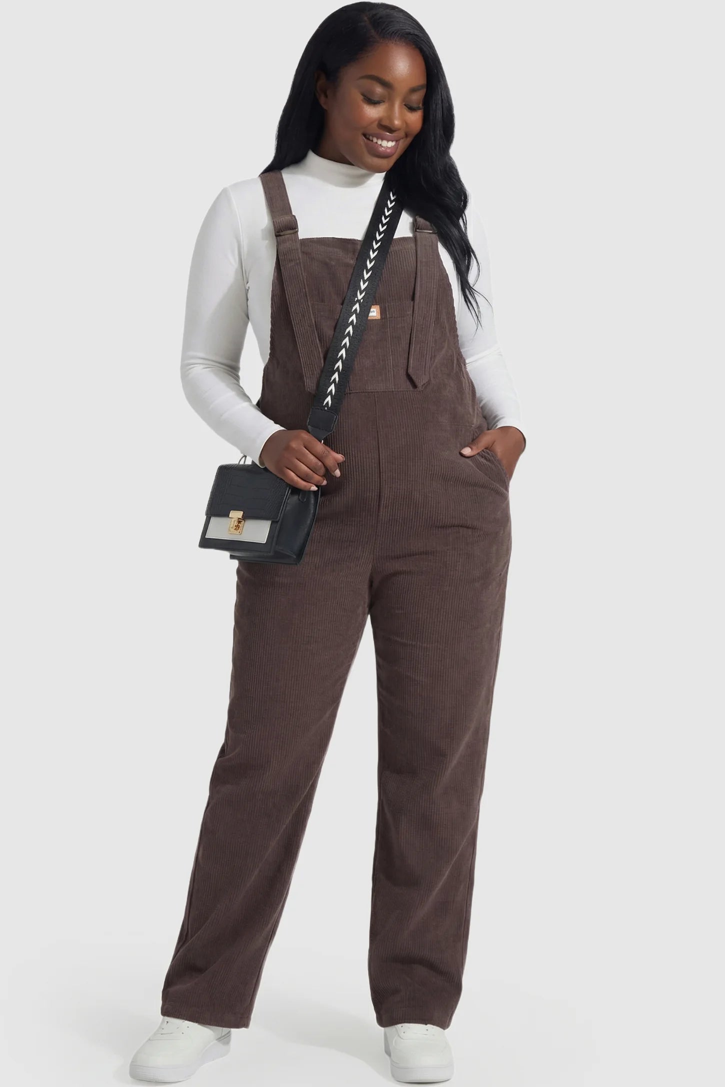 Wide leg side stretch panel maternity overalls in brown featuring flexible side panels on a pregnant model