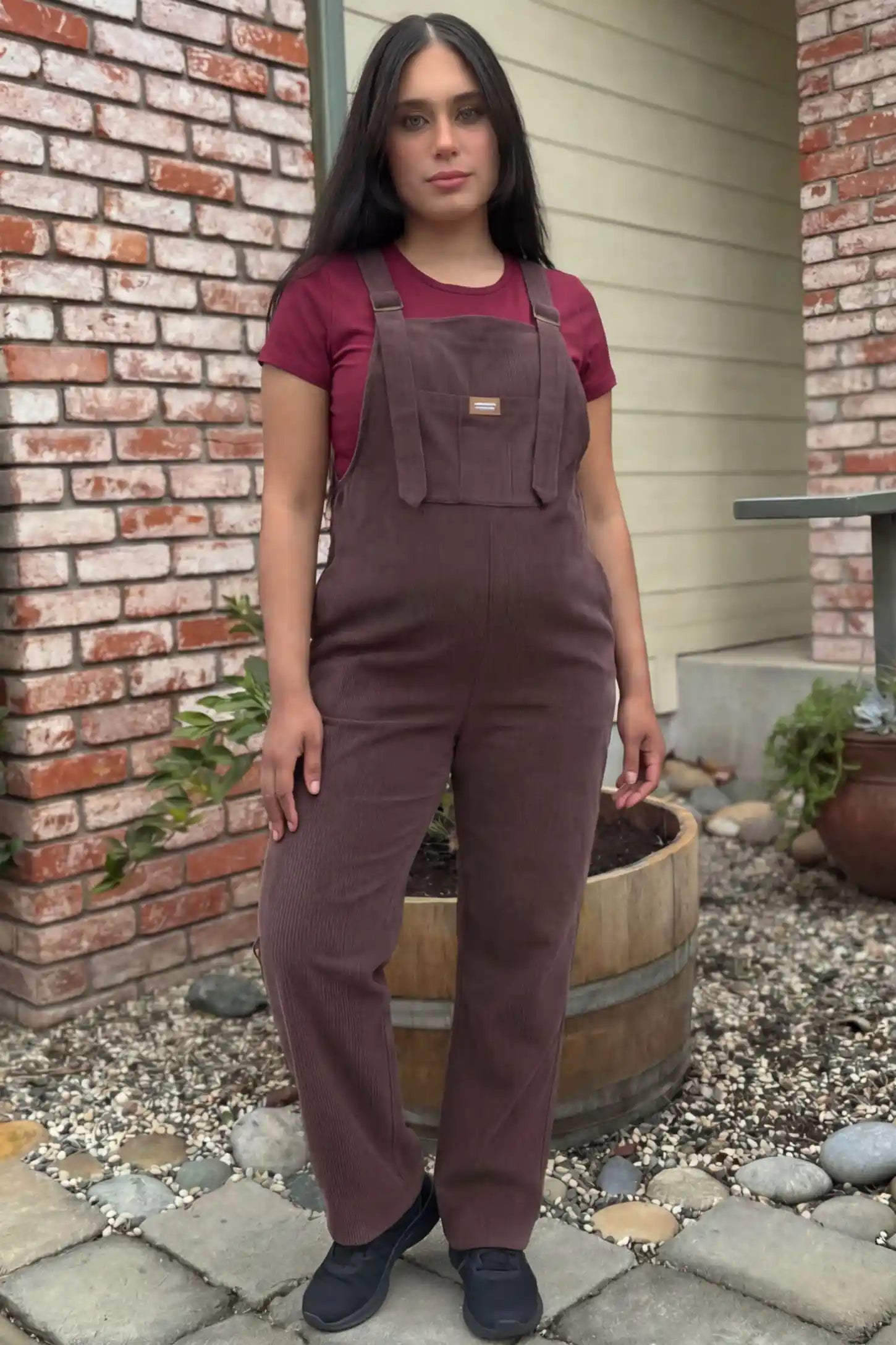 Wide Leg Side Stretch Panel Maternity Overalls Wide leg side stretch panel maternity overalls in brown featuring flexible side panels on a pregnant model