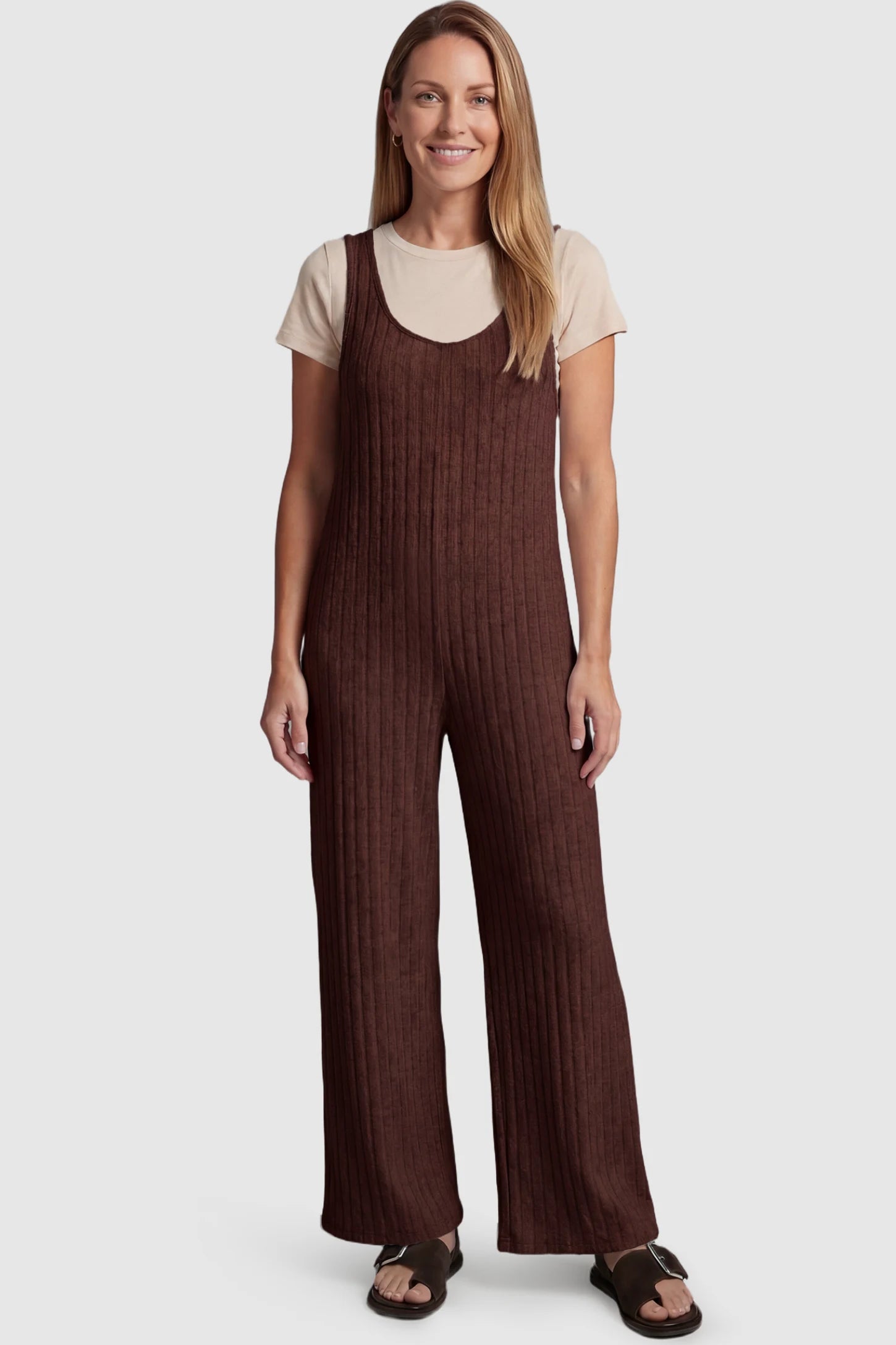Ribbed Sleeveless Wide-Leg Maternity Jumpsuit Ribbed sleeveless wide-leg maternity jumpsuit in dark brown with sleeveless ribbed design, front view on postpartum model