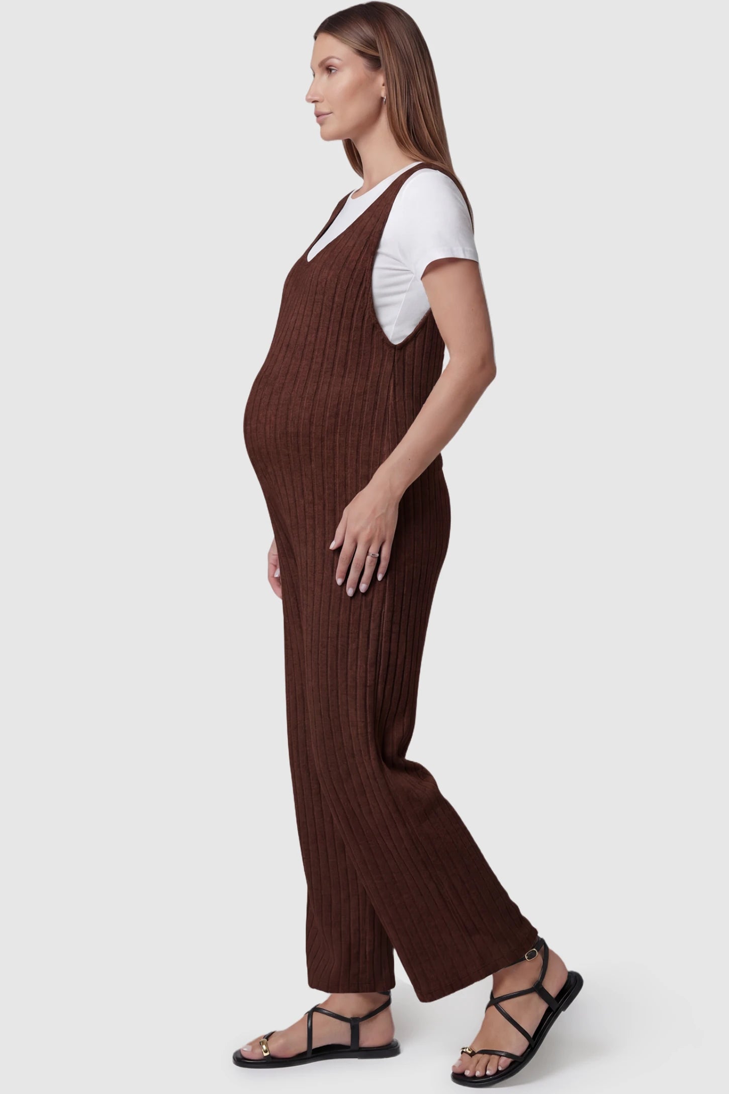 Ribbed Sleeveless Wide-Leg Maternity Jumpsuit Ribbed sleeveless wide-leg maternity jumpsuit in dark brown with sleeveless ribbed design, side view on pregnant model