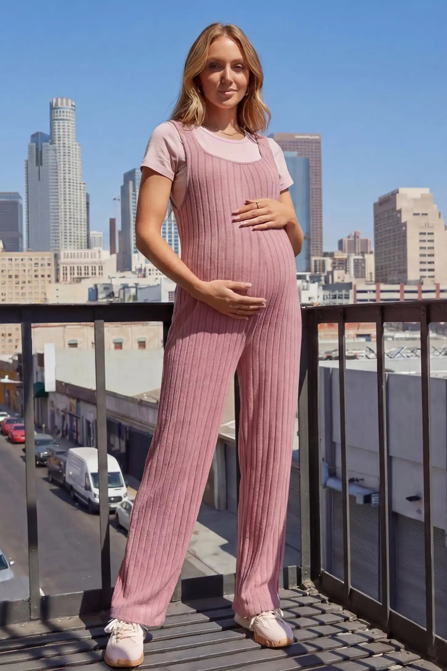Ribbed Sleeveless Wide-Leg Maternity Jumpsuit Ribbed sleeveless wide-leg maternity jumpsuit in dark pink with sleeveless ribbed design, front view on pregnant model