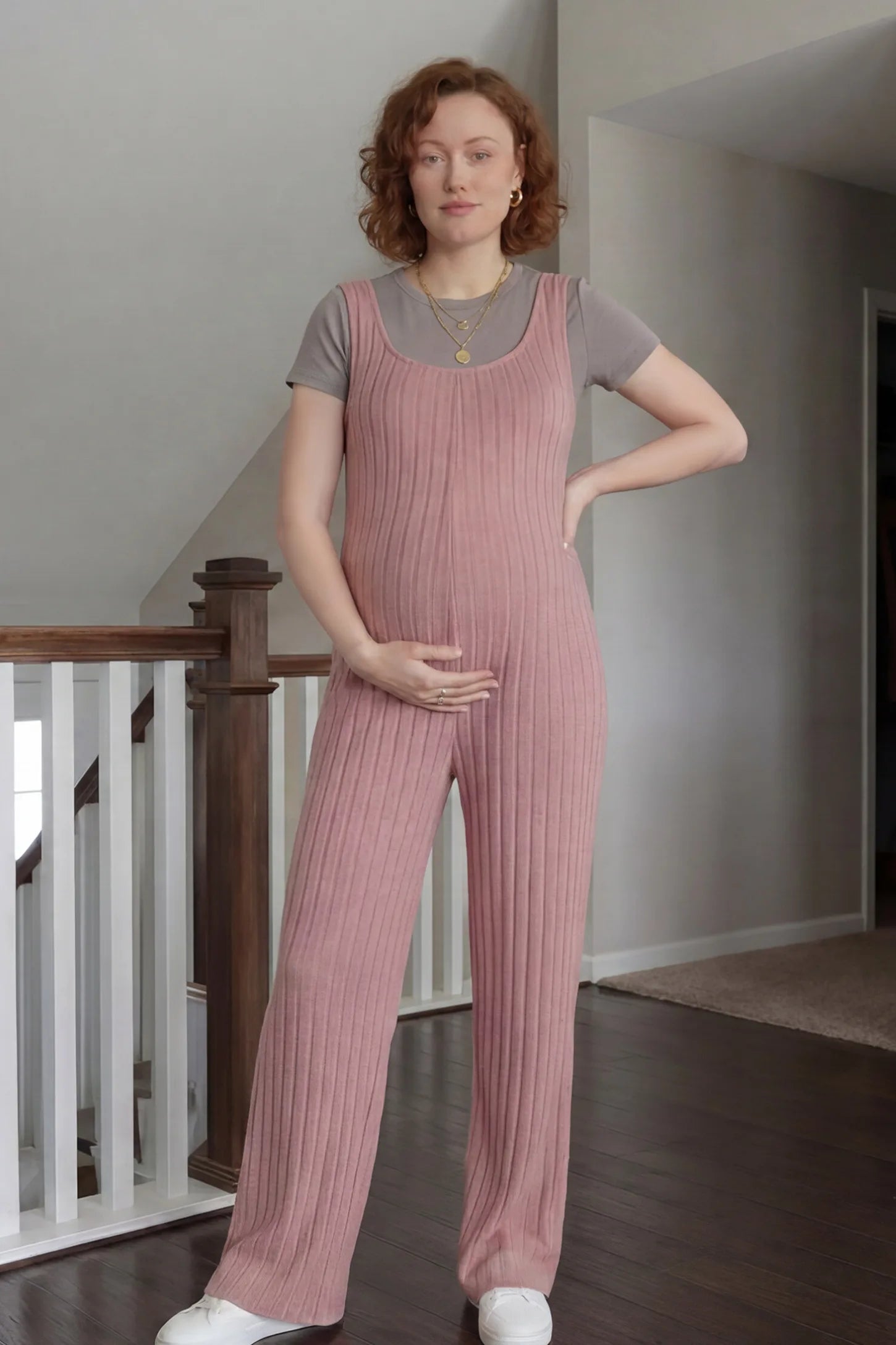 Ribbed Sleeveless Wide-Leg Maternity Jumpsuit Ribbed sleeveless wide-leg maternity jumpsuit in dark pink with sleeveless ribbed design, front view on pregnant model