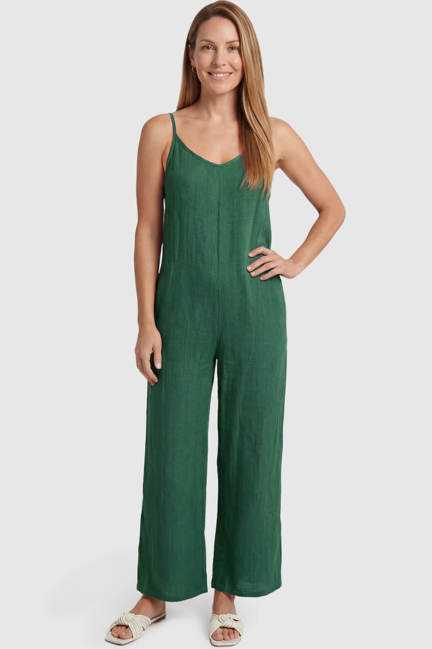 Wide‑Leg Scoop Neck Pocketed Maternity Jumpsuit Wide-leg scoop neck pocketed maternity jumpsuit in green with sleeveless design, thin strap, and wide-leg silhouette, front view on postpartum model
