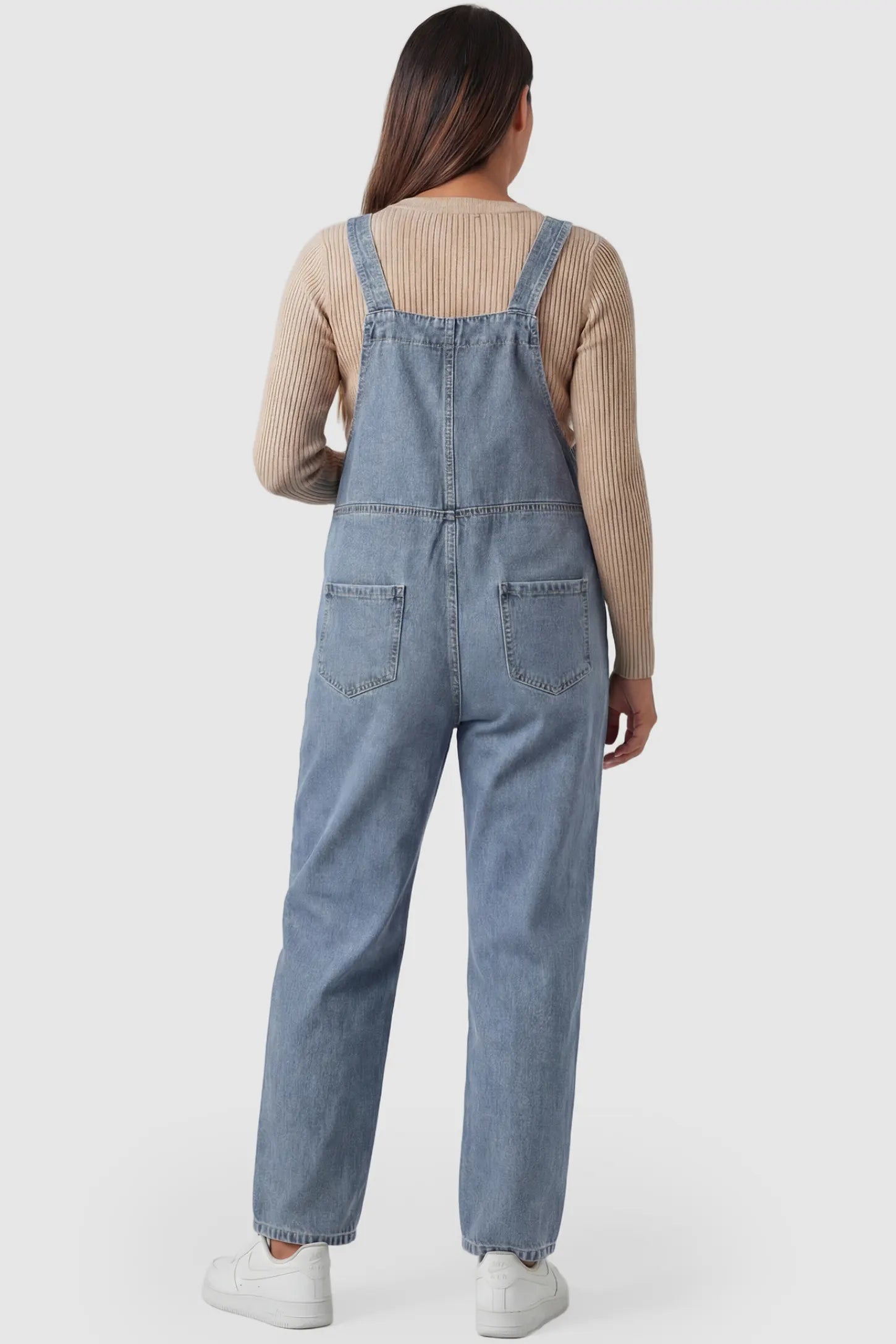 Wide Leg Relaxed Fit Maternity Overalls Wide leg relaxed fit maternity overalls in light blue denim featuring adjustable straps on a pregnant model