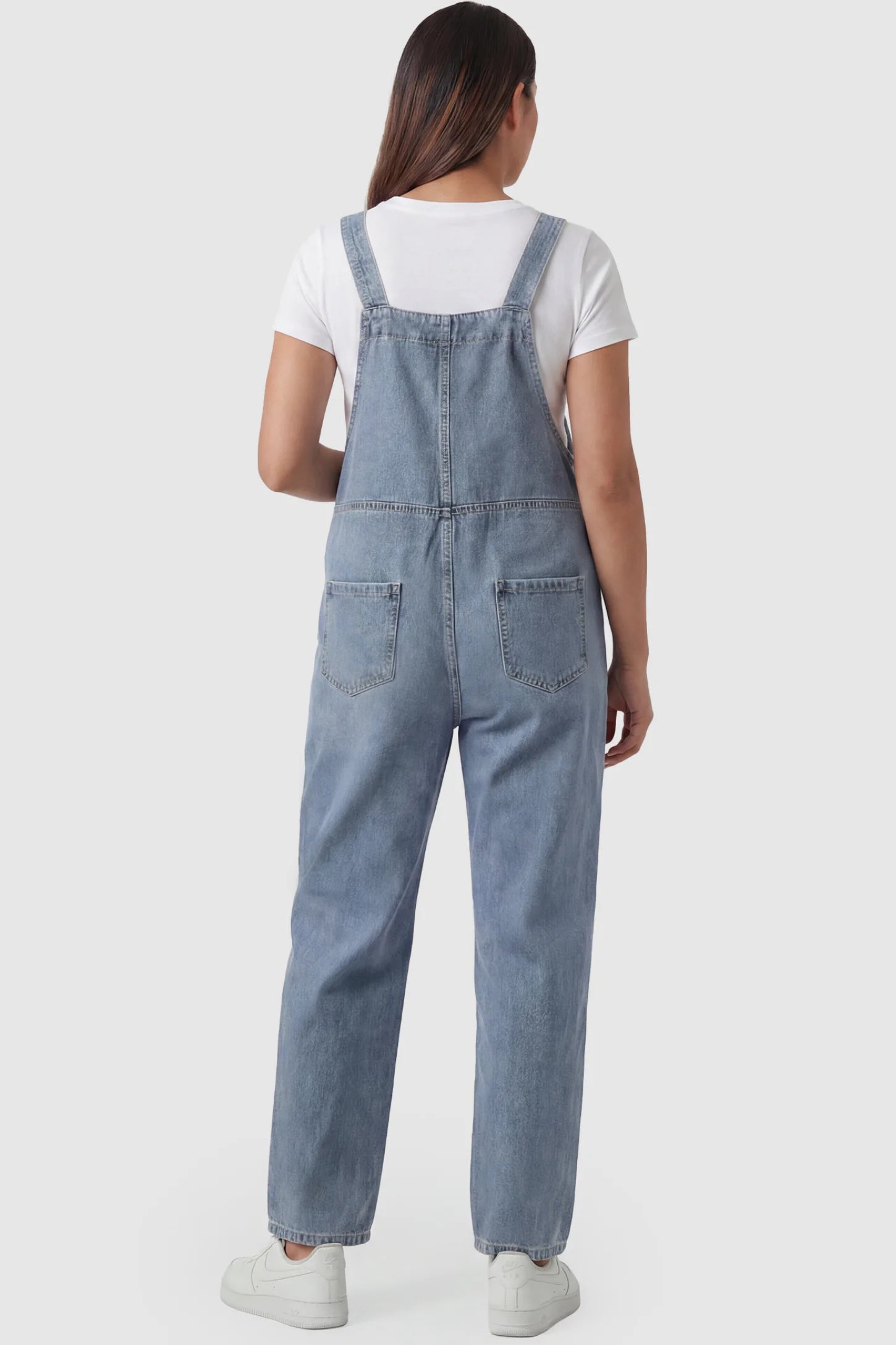 Wide Leg Relaxed Fit Maternity Overalls Wide leg relaxed fit maternity overalls in light blue with back pockets, back view on pregnant model