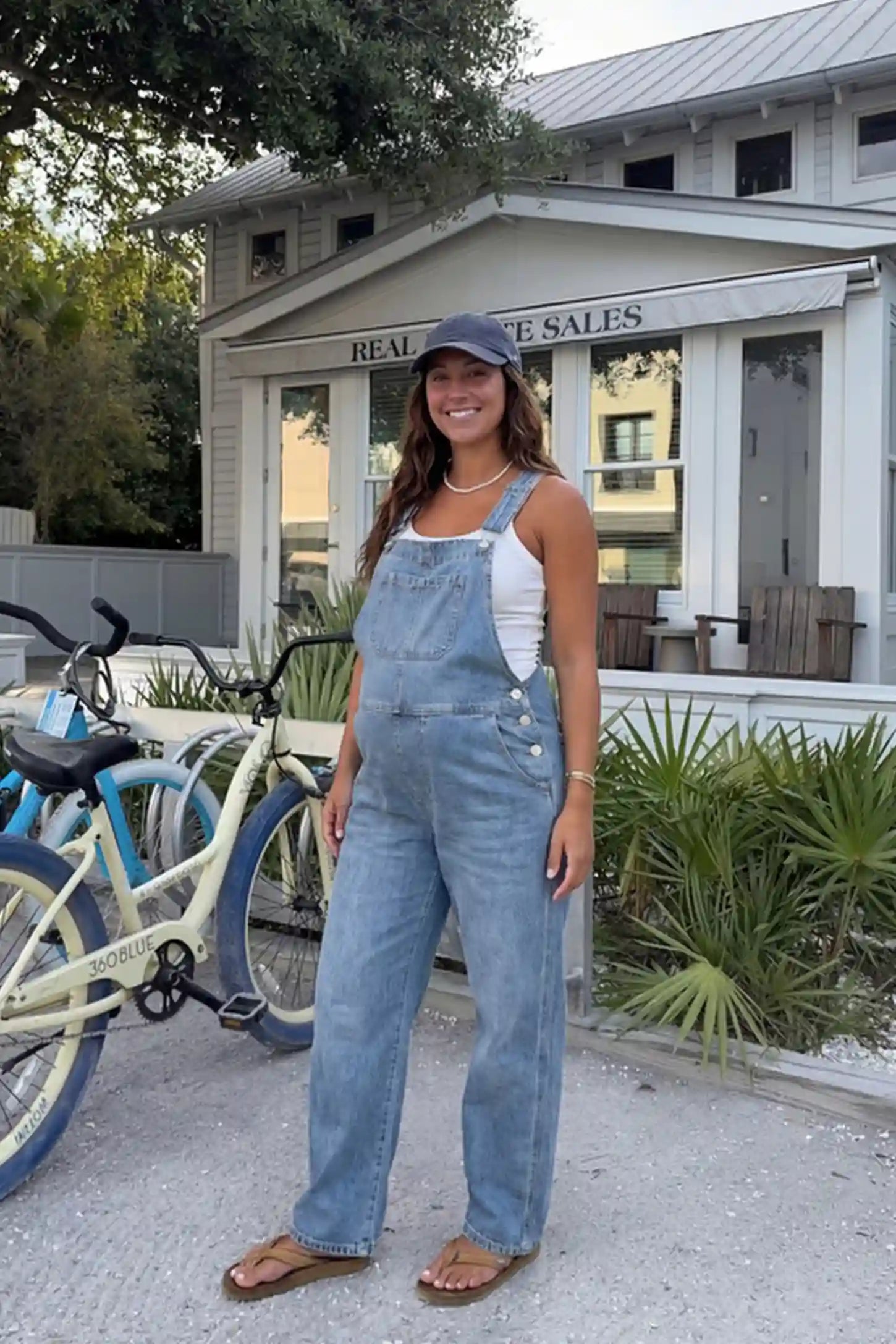 Wide Leg Relaxed Fit Maternity Overalls Wide leg relaxed fit maternity overalls in light blue with adjustable straps and front pockets, front view on pregnant model