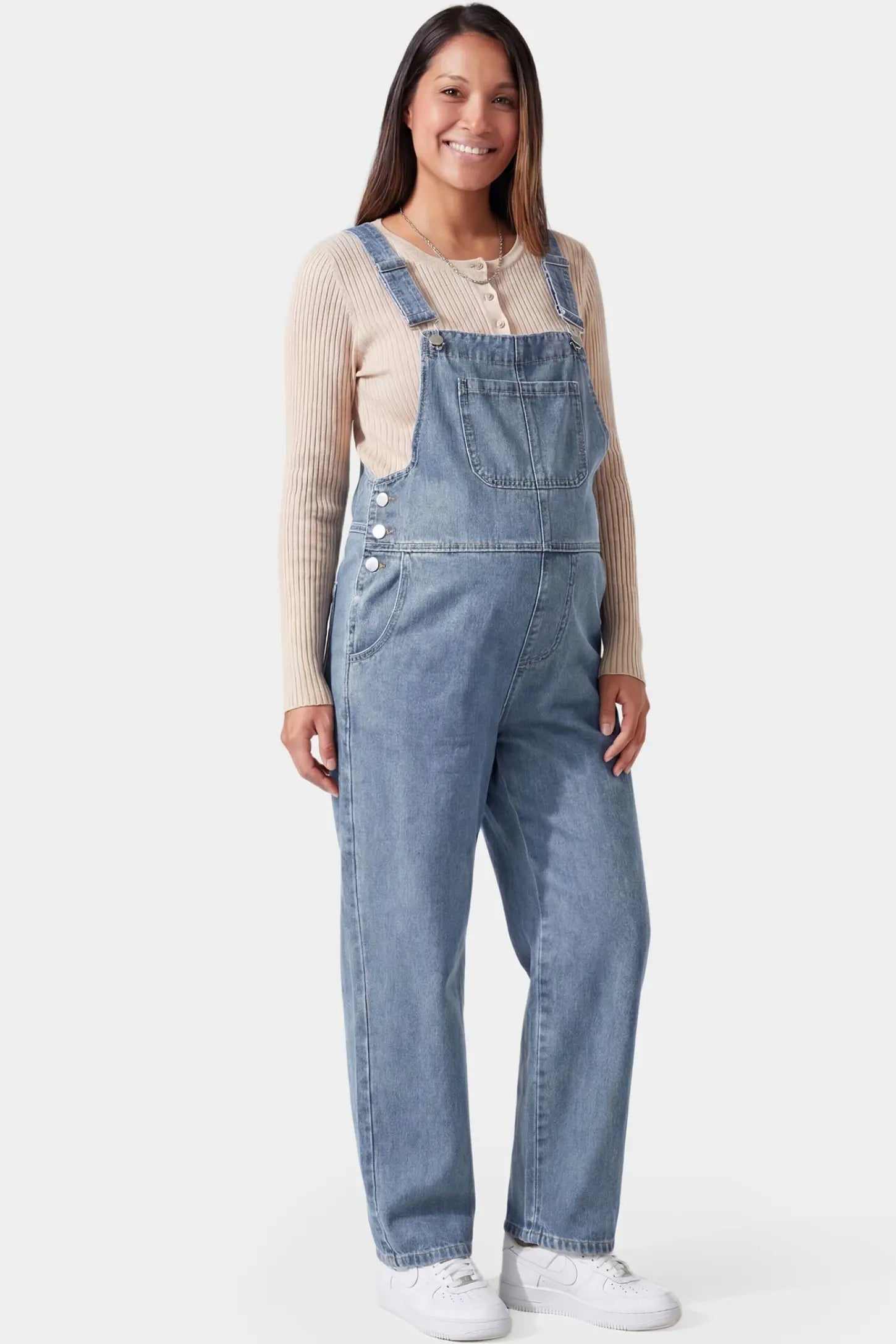 Wide leg relaxed fit maternity overalls in light blue denim featuring adjustable straps on a pregnant model
