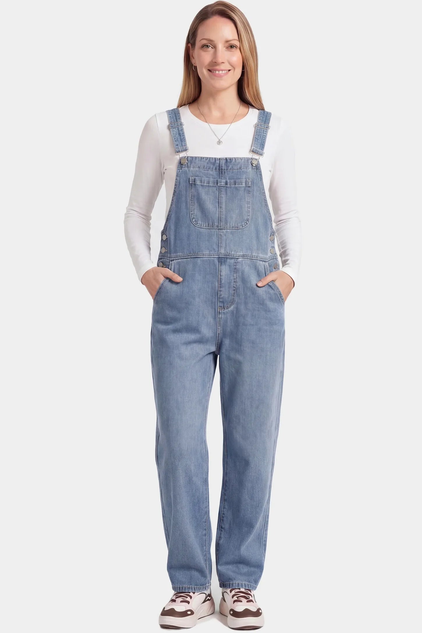 Wide Leg Relaxed Fit Maternity Overalls Wide leg relaxed fit maternity overalls in light blue denim featuring adjustable straps on a pregnant model