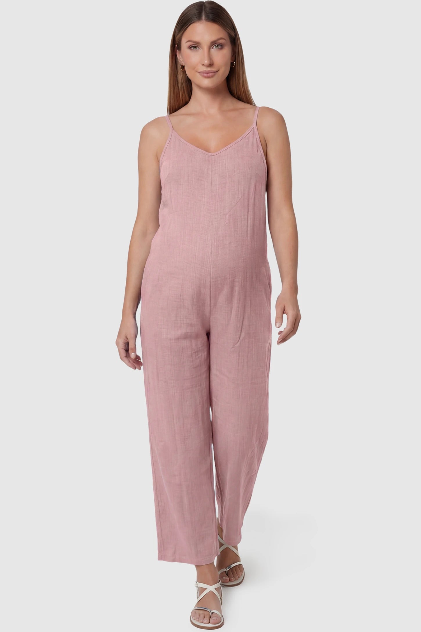 Wide‑Leg Scoop Neck Pocketed Maternity Jumpsuit Wide-leg scoop neck pocketed maternity jumpsuit in pink with sleeveless design, thin strap, and wide-leg silhouette, front view on pregnant model