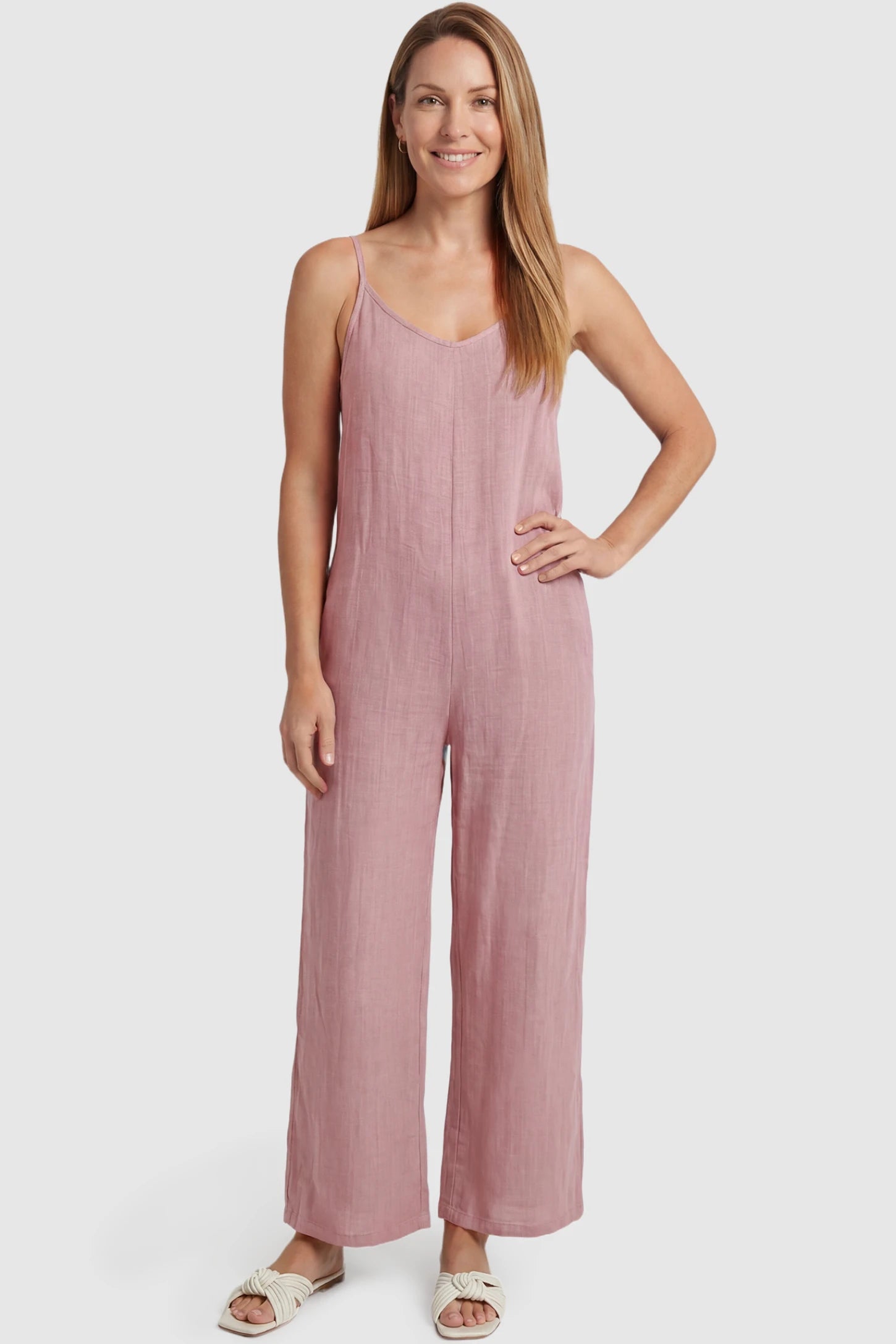 Wide‑Leg Scoop Neck Pocketed Maternity Jumpsuit Wide-leg scoop neck pocketed maternity jumpsuit in pink with sleeveless design, thin strap, and wide-leg silhouette, front view on postpartum model