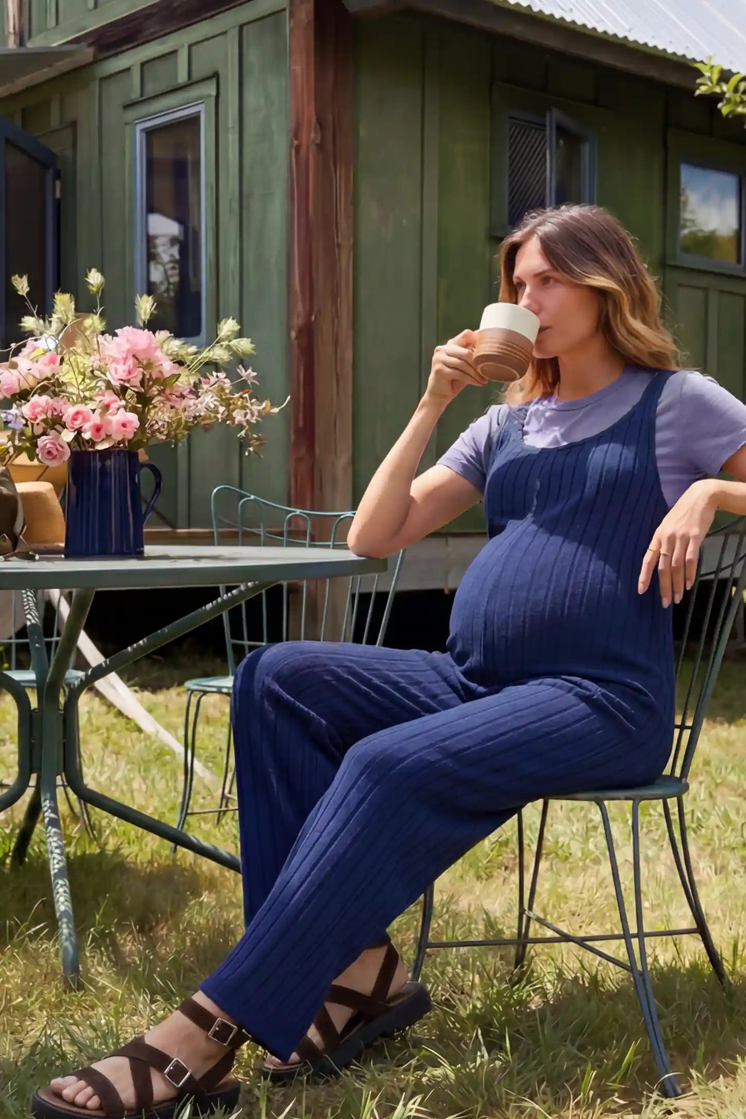 Ribbed Sleeveless Wide-Leg Maternity Jumpsuit Ribbed sleeveless wide-leg maternity jumpsuit in royal blue with sleeveless ribbed design, side view on pregnant model