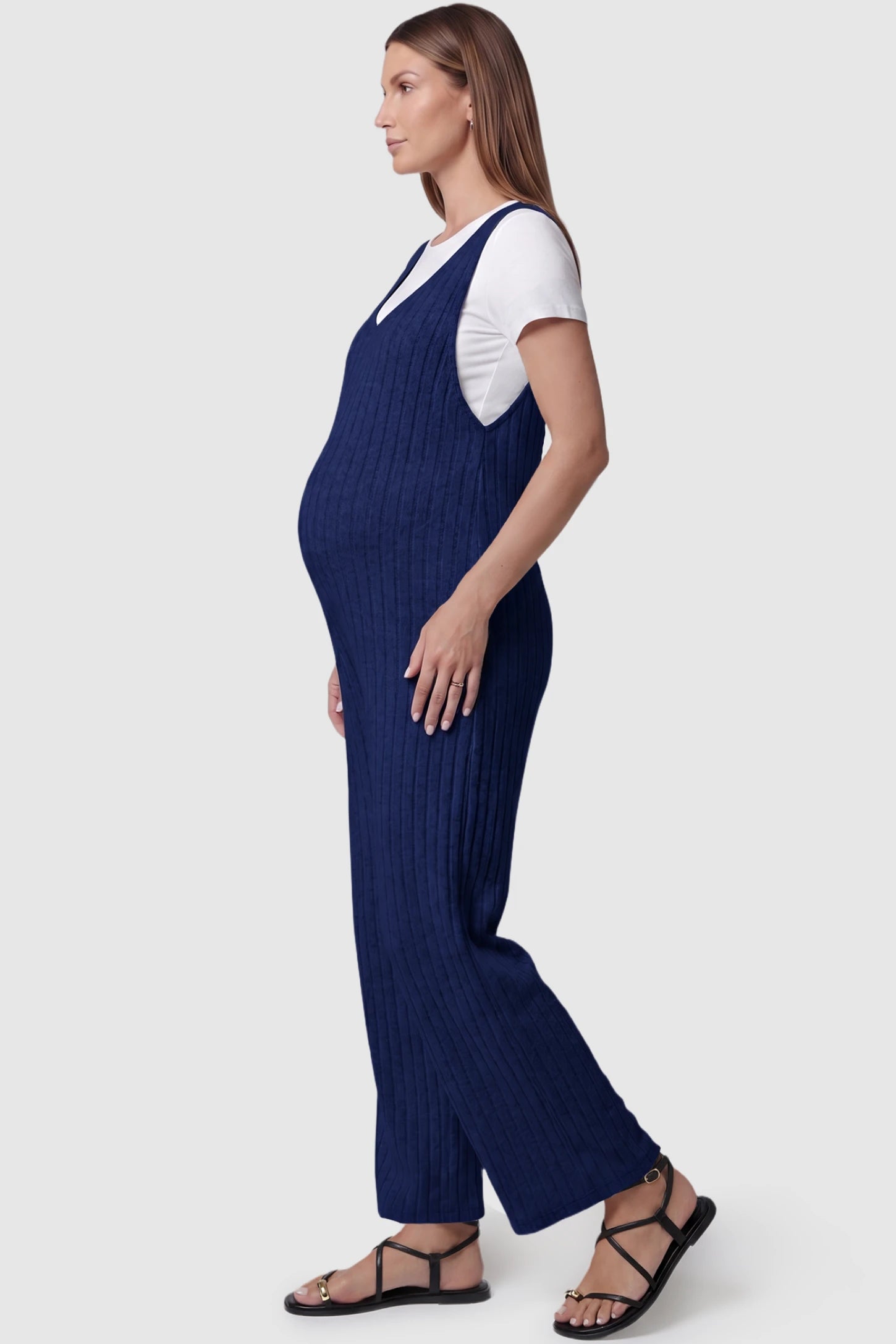 Ribbed Sleeveless Wide-Leg Maternity Jumpsuit Ribbed sleeveless wide-leg maternity jumpsuit in royal blue with sleeveless ribbed design, side view on pregnant model
