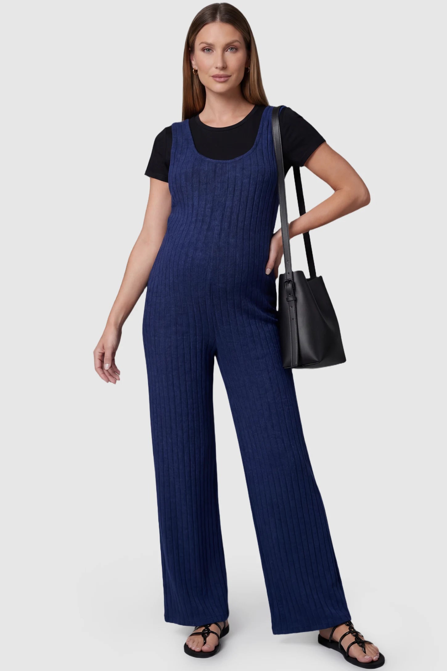 Ribbed Sleeveless Wide-Leg Maternity Jumpsuit Ribbed sleeveless wide-leg maternity jumpsuit in royal blue with sleeveless ribbed design, front view on pregnant model