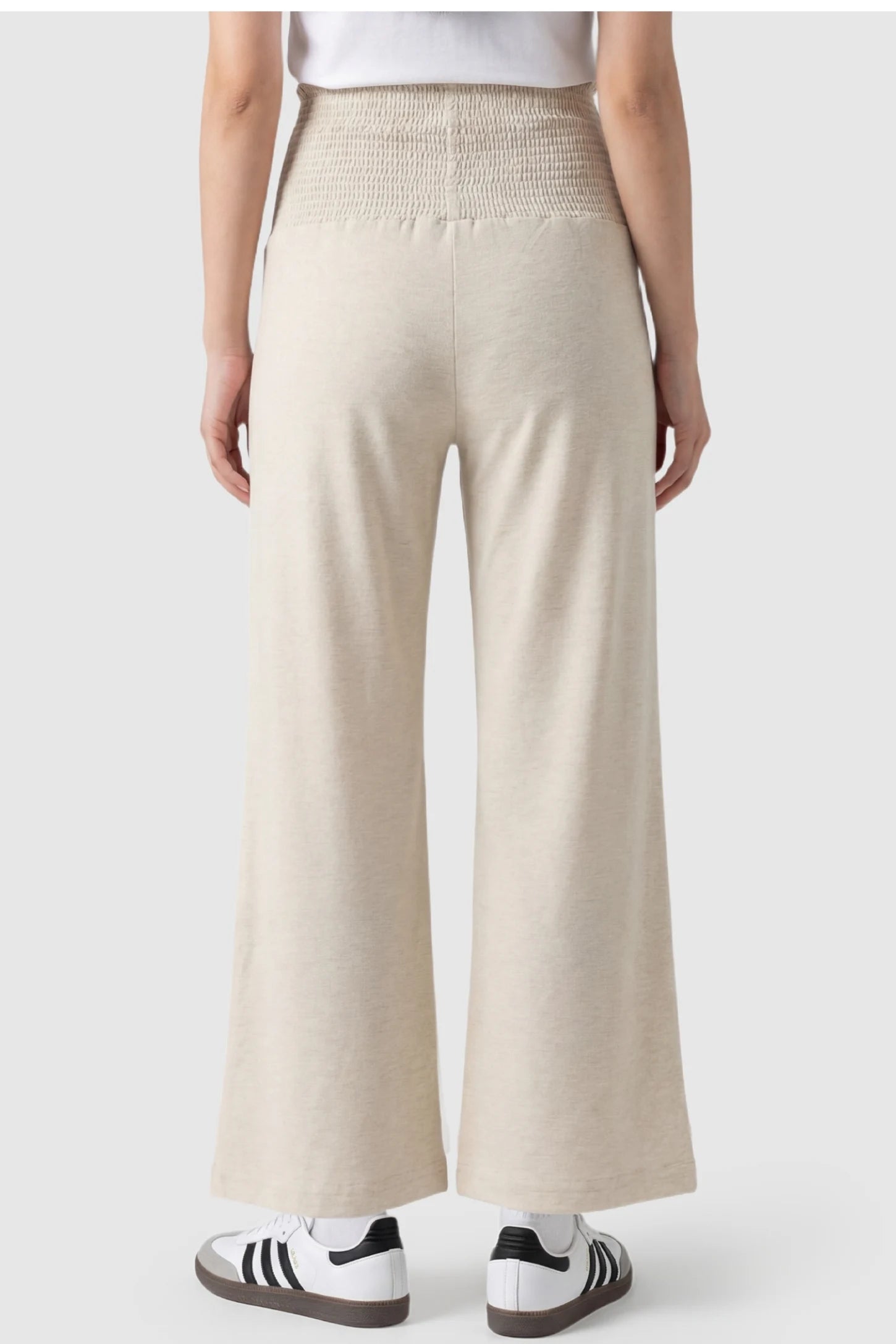 Stretch Waistband High-Waist Wide-Leg Maternity Pants High-waist wide-leg maternity pants in beige with wide-leg silhouette, back view on pregnant model