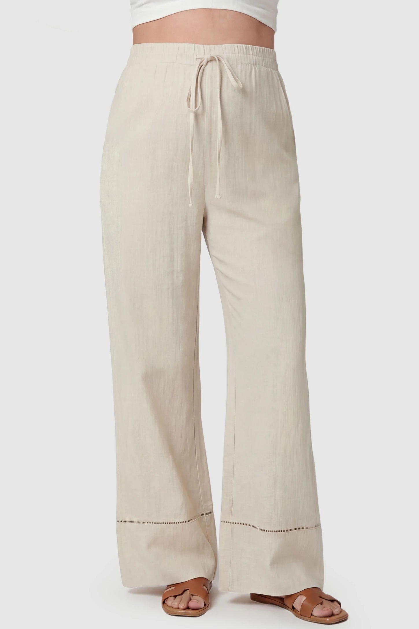 High-Waist Drawstring Wide-Leg Maternity Pants High-waist drawstring wide-leg maternity pants in beige with adjustable waistband, front view on pregnant model