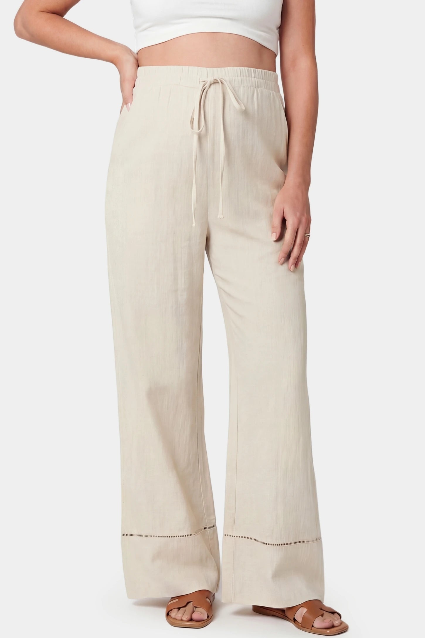 High-Waist Drawstring Wide-Leg Maternity Pants High-waist drawstring wide-leg maternity pants in beige with adjustable waistband, front view on pregnant model