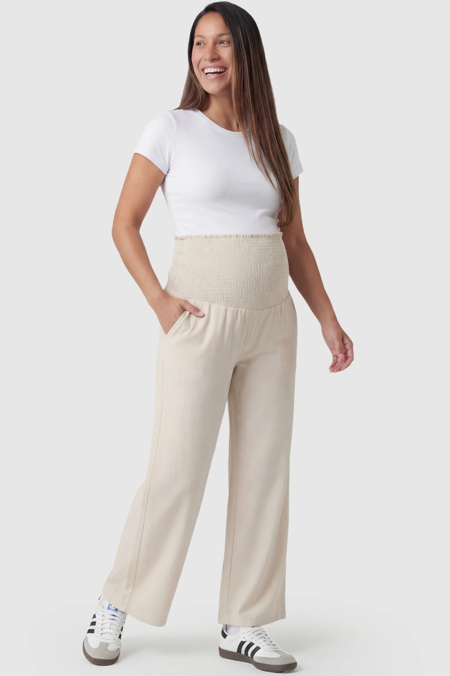 Stretch Waistband High-Waist Wide-Leg Maternity Pants High-waist wide-leg maternity pants in beige with relaxed drape, full body on pregnant model