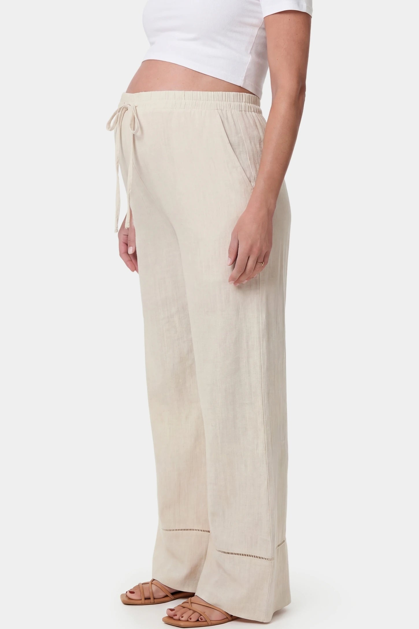 High-Waist Drawstring Wide-Leg Maternity Pants High-waist drawstring wide-leg maternity pants in beige with side pockets, side view on pregnant model