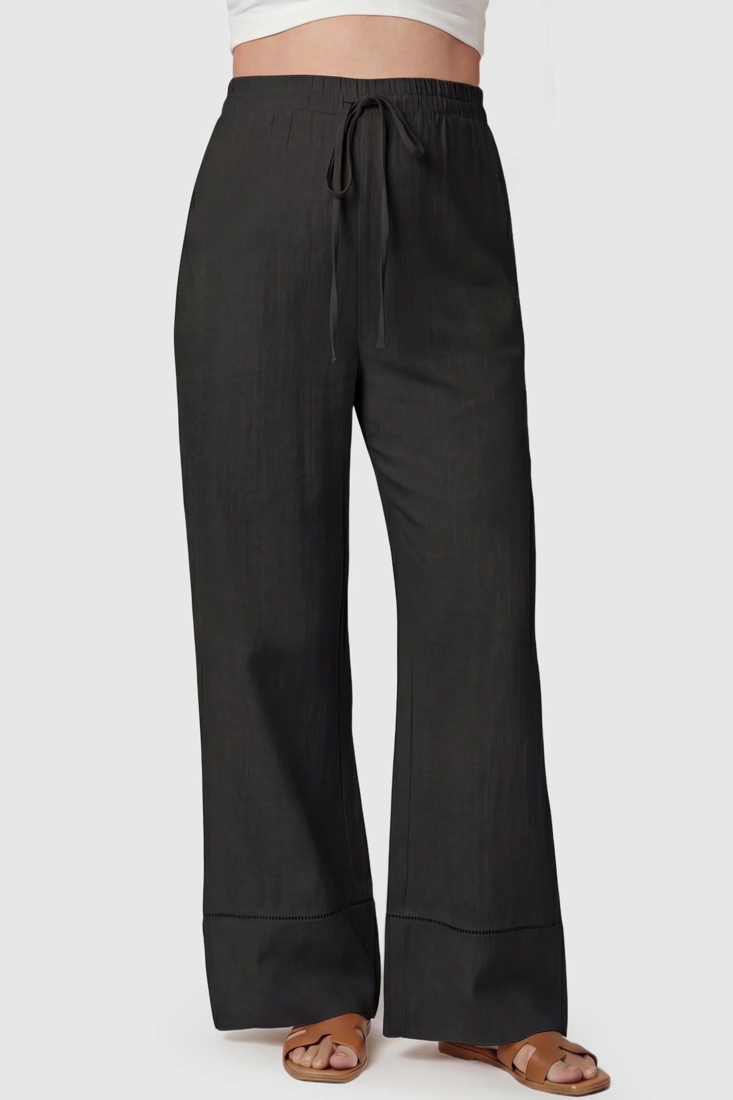High-waist drawstring wide-leg maternity pants in black with adjustable waistband, front view on pregnant model