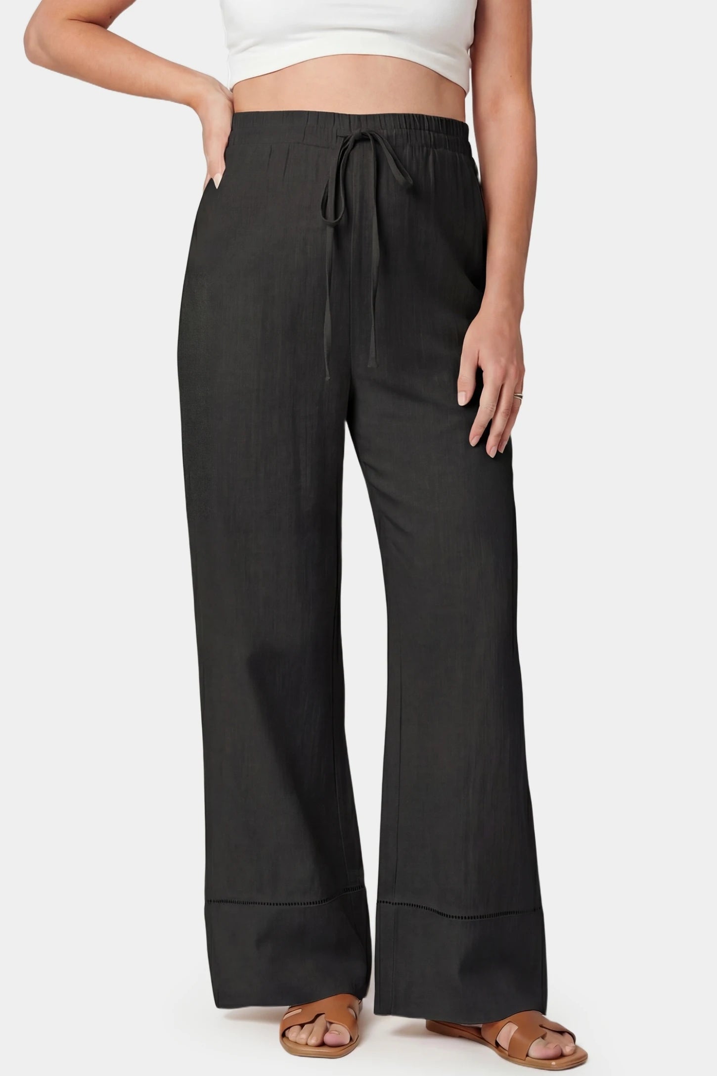 High-waist drawstring wide-leg maternity pants in black with adjustable waistband, front view on pregnant model