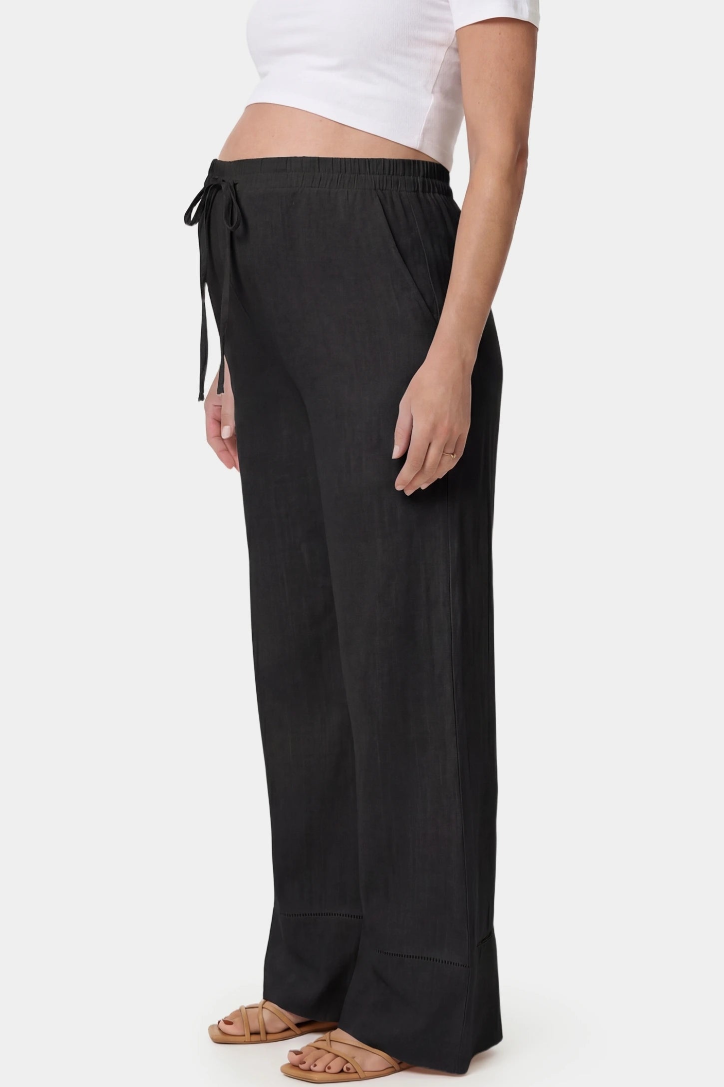 High-Waist Drawstring Wide-Leg Maternity Pants High-waist drawstring wide-leg maternity pants in black with side pockets, side view on pregnant model