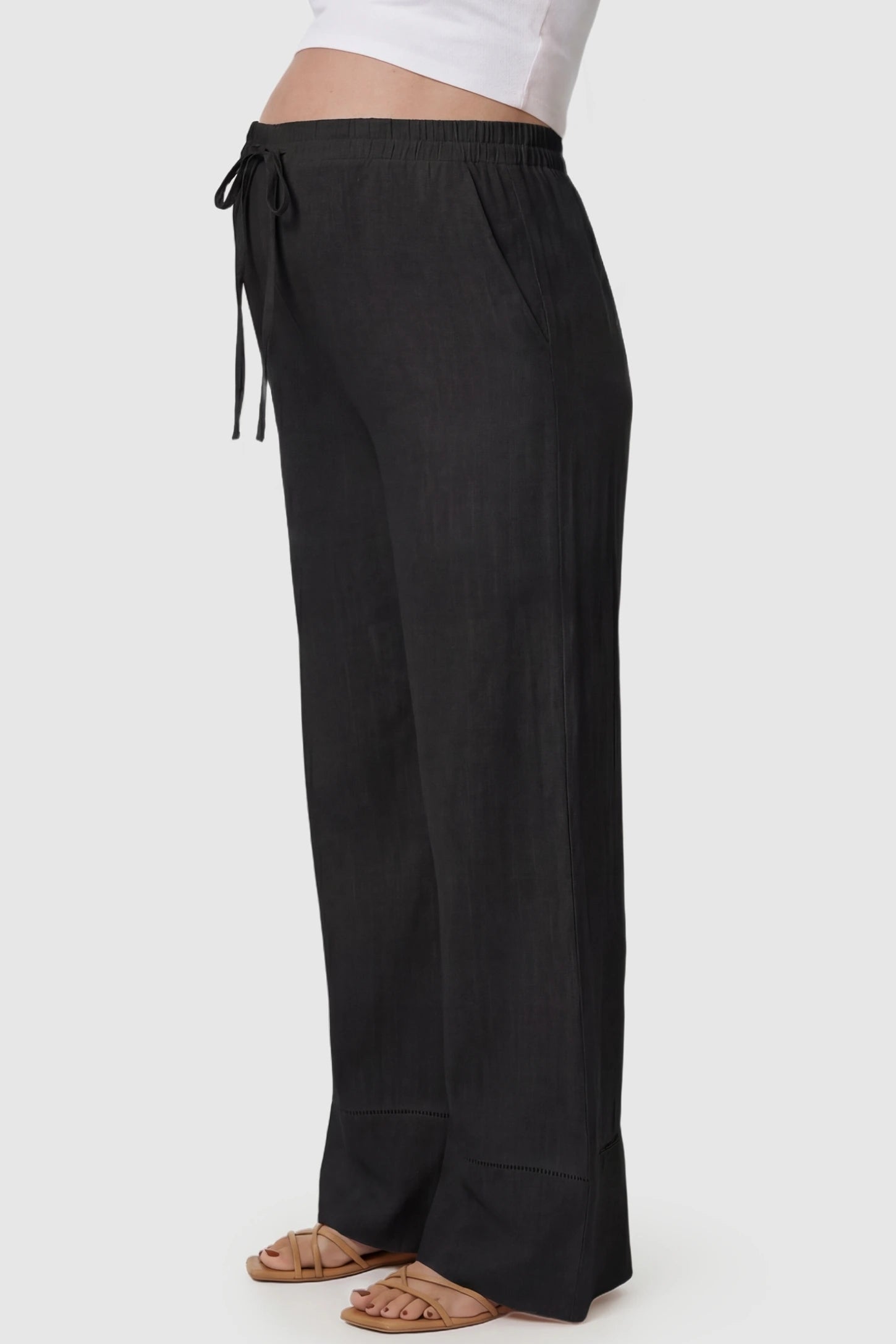 High-Waist Drawstring Wide-Leg Maternity Pants High-waist drawstring wide-leg maternity pants in black with side pockets, side view on pregnant model