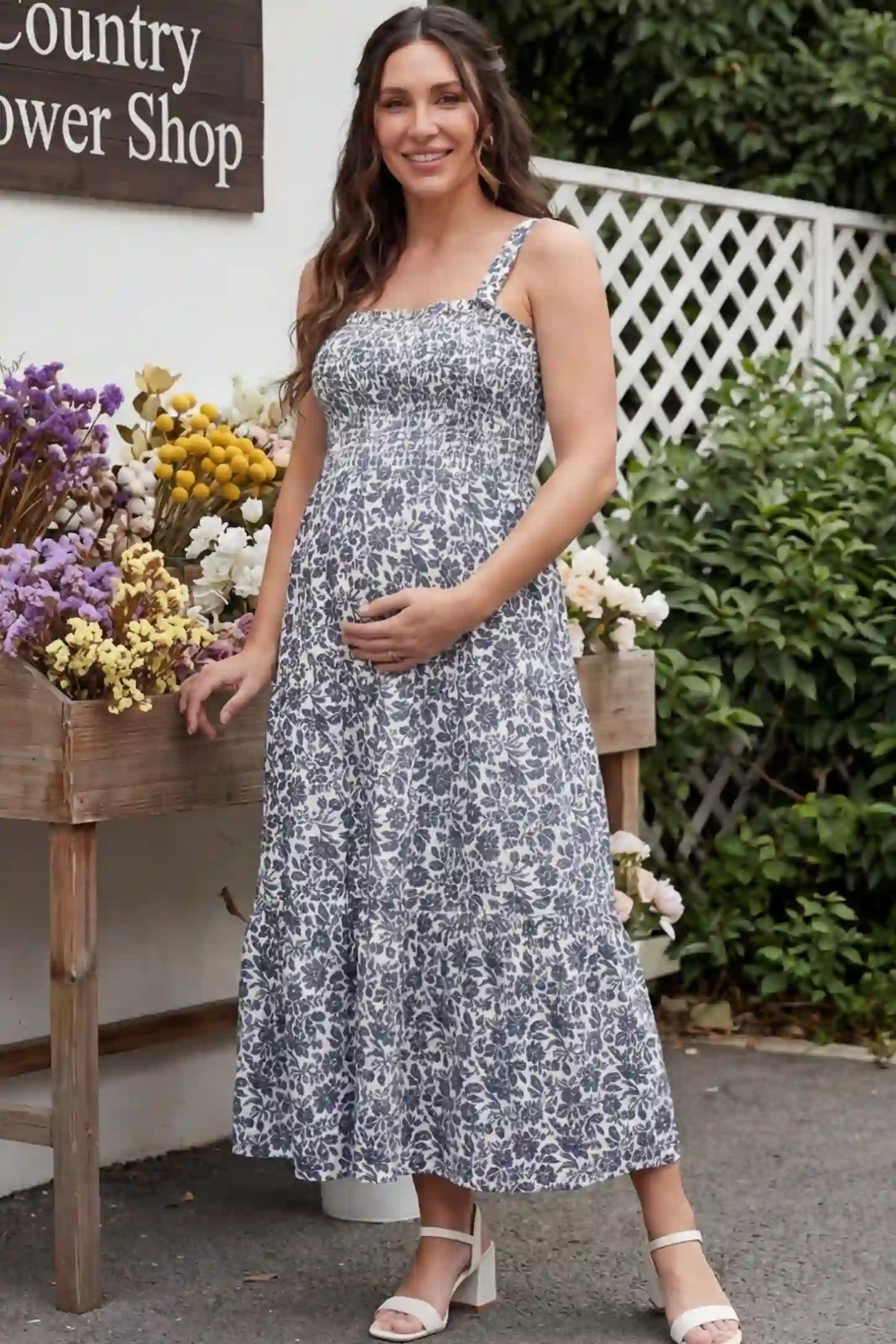 Floral Print Square Neck Tiered Maternity Sundress Floral Print Square Neck Tiered Maternity Sundress in navy blue featuring smocked bodice and wide straps on pregnant woman front view
