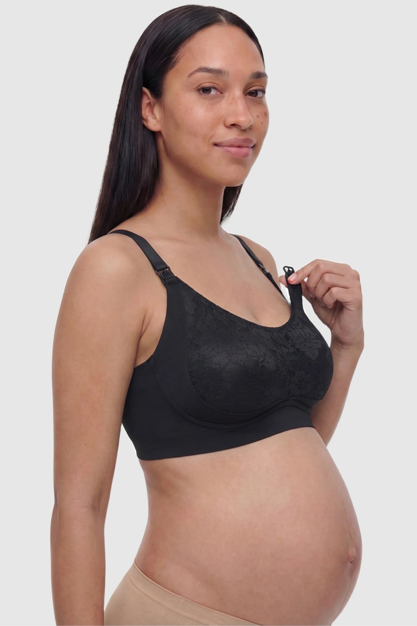 Wireless Front-Open Scalloped Lace Maternity Nursing Bra Wireless Front-Open Scalloped Lace Maternity Nursing Bra in Black featuring easy-access front nursing clips on a side angle view of a pregnant model.