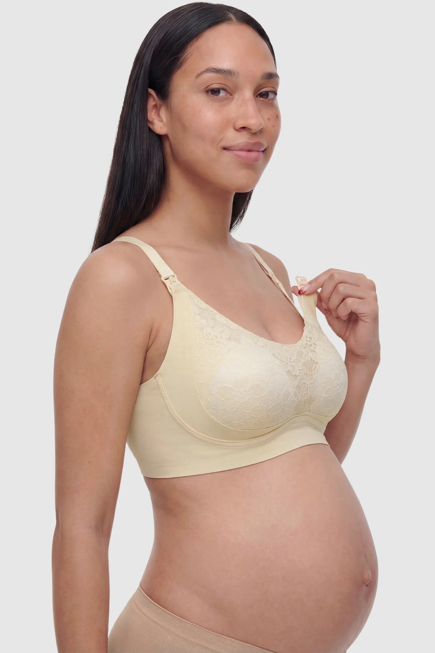 Wireless Front-Open Scalloped Lace Maternity Nursing Bra Wireless Front-Open Scalloped Lace Maternity Nursing Bra in Skin featuring functional front nursing clips on a side angle view of a pregnant model.