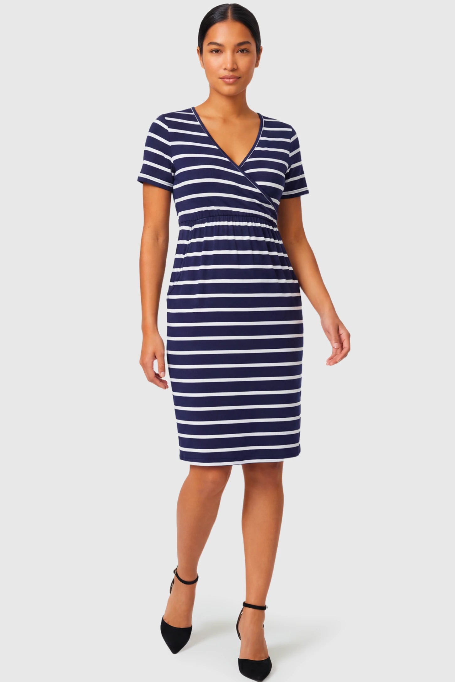 Short Sleeve Faux Wrap Maternity & Nursing Midi Dress Short Sleeve Faux Wrap Maternity & Nursing Midi Dress in navy striped print featuring V-neck faux wrap bodice and empire waist on a non pregnant model.