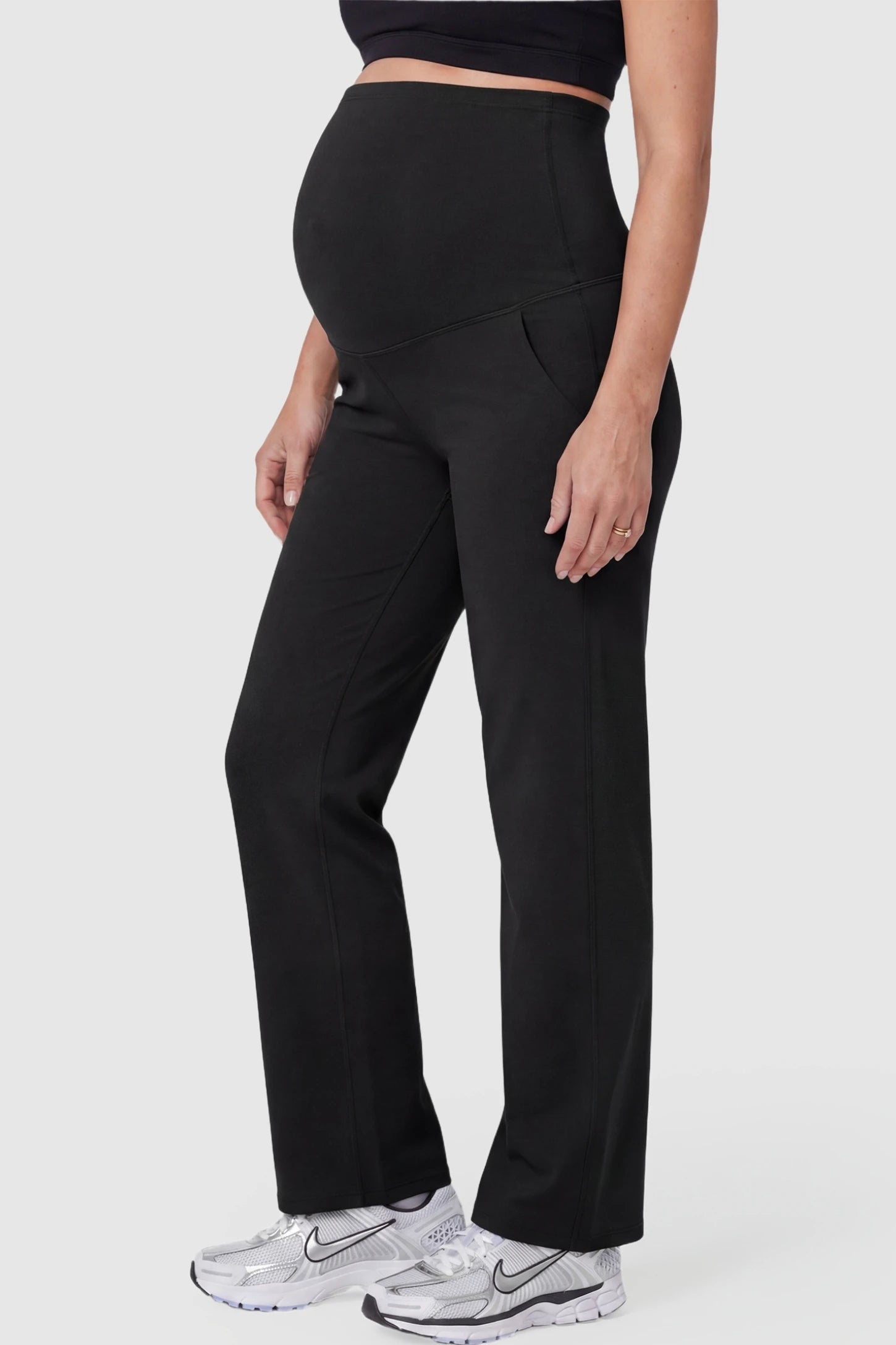 Suede-Finish High-Waisted Straight Leg Yoga Maternity Pants Suede-finish high-waisted straight leg yoga maternity pants in black with zippered pockets, side view on pregnant model