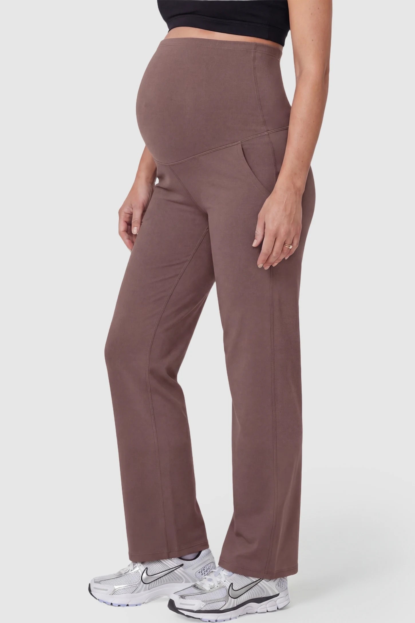 Suede-Finish High-Waisted Straight Leg Yoga Maternity Pants Suede-finish high-waisted straight leg yoga maternity pants in brown with zippered pockets, side view on pregnant model