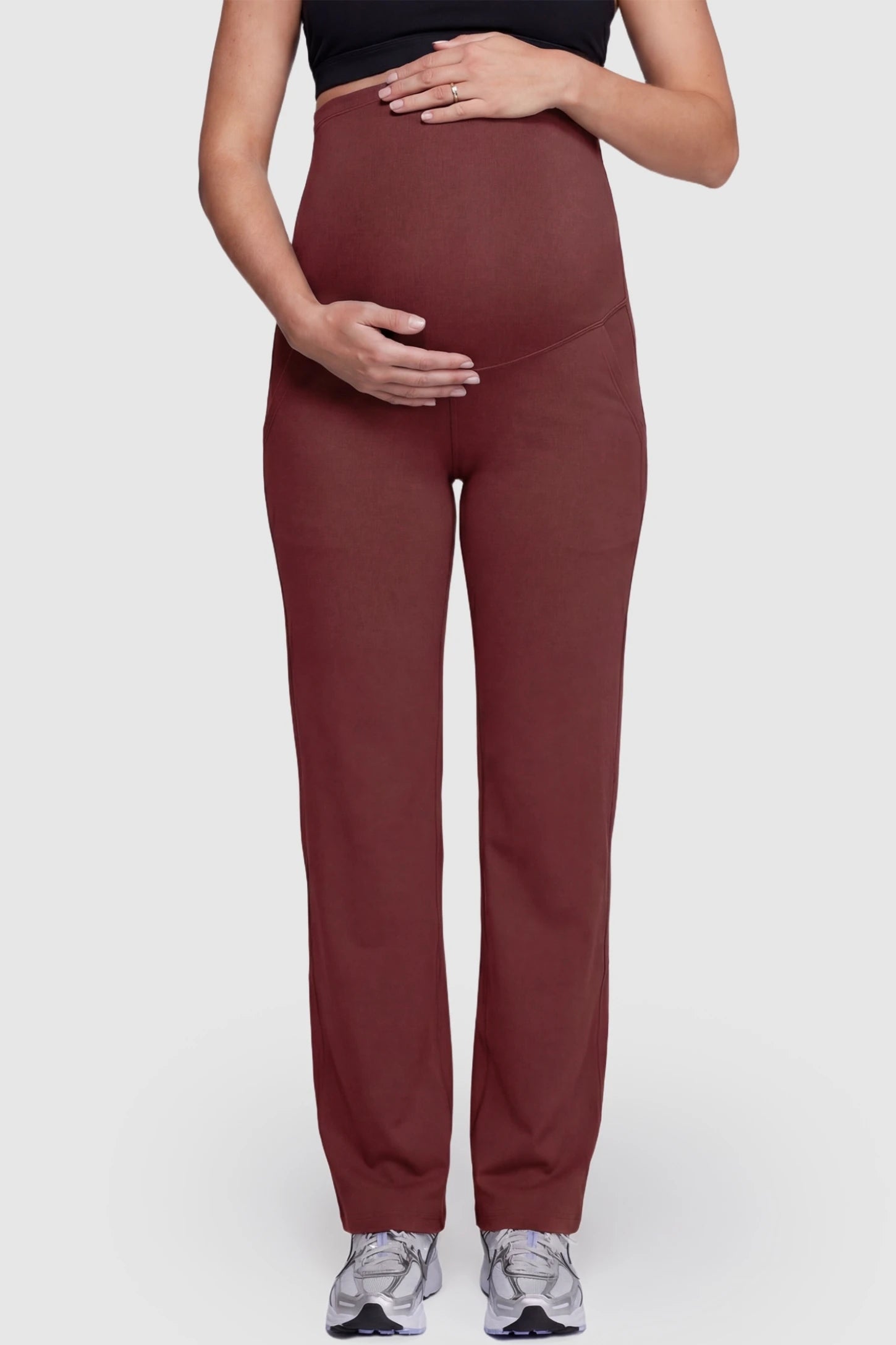 Suede-Finish High-Waisted Straight Leg Yoga Maternity Pants Suede-finish high-waisted straight leg yoga maternity pants in burgundy with belly support band, front view on pregnant model