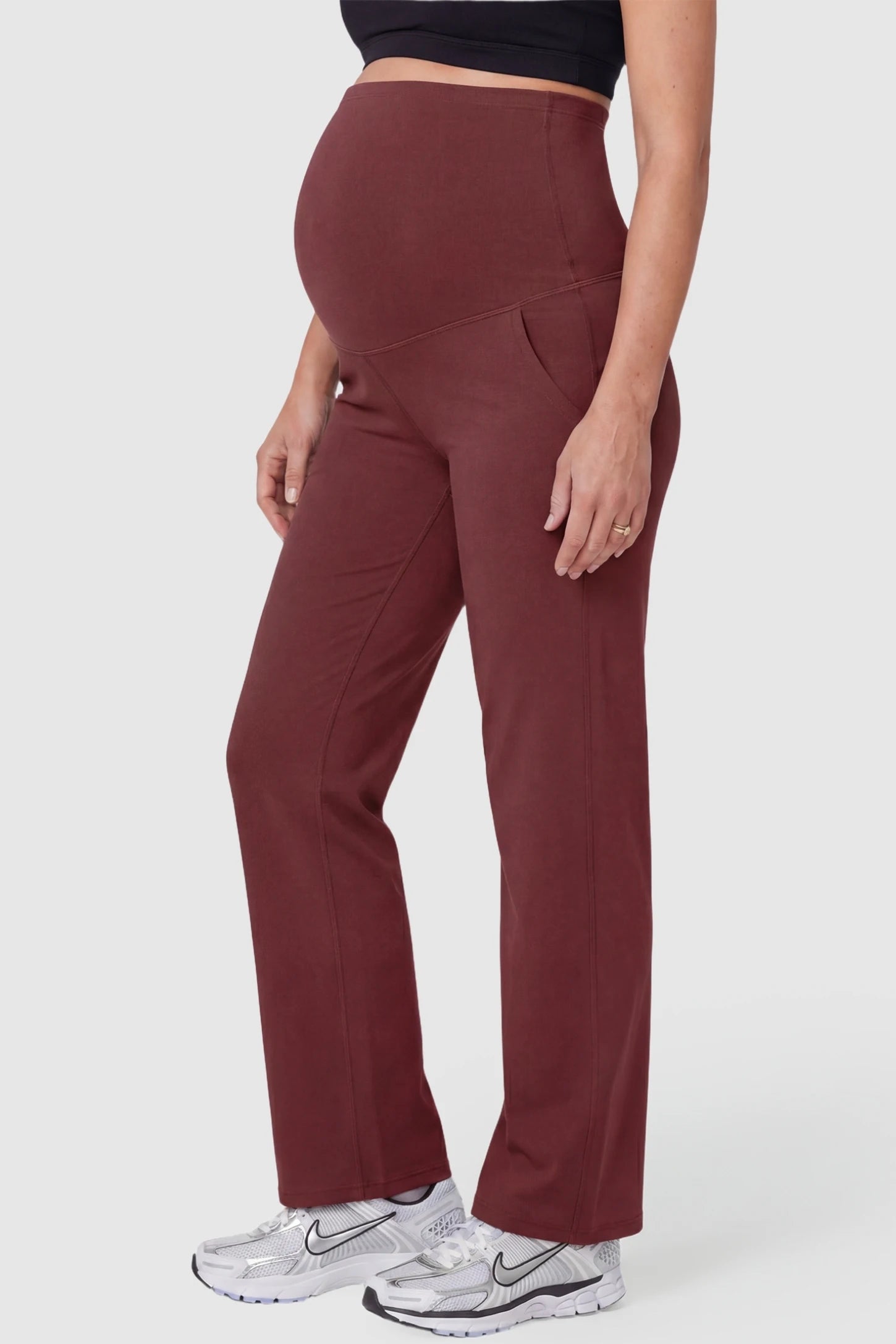 Suede-Finish High-Waisted Straight Leg Yoga Maternity Pants Suede-finish high-waisted straight leg yoga maternity pants in burgundy with zippered pockets, side view on pregnant model