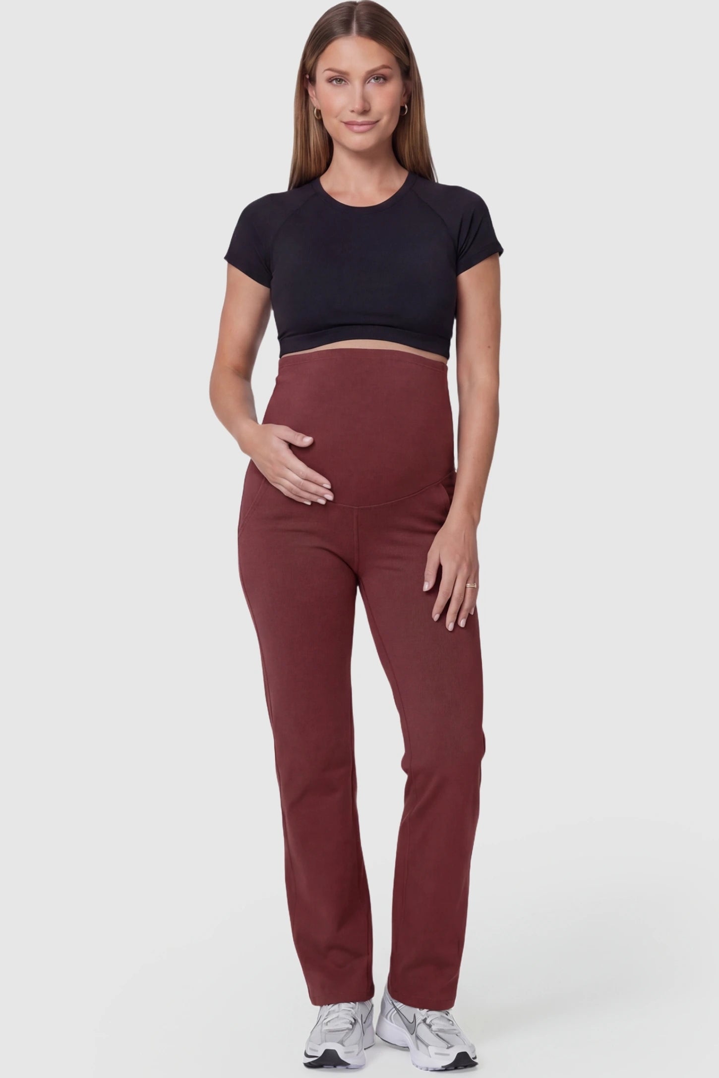 Suede-Finish High-Waisted Straight Leg Yoga Maternity Pants Suede-finish high-waisted straight leg yoga maternity pants in burgundy with straight leg cut, full body on pregnant model