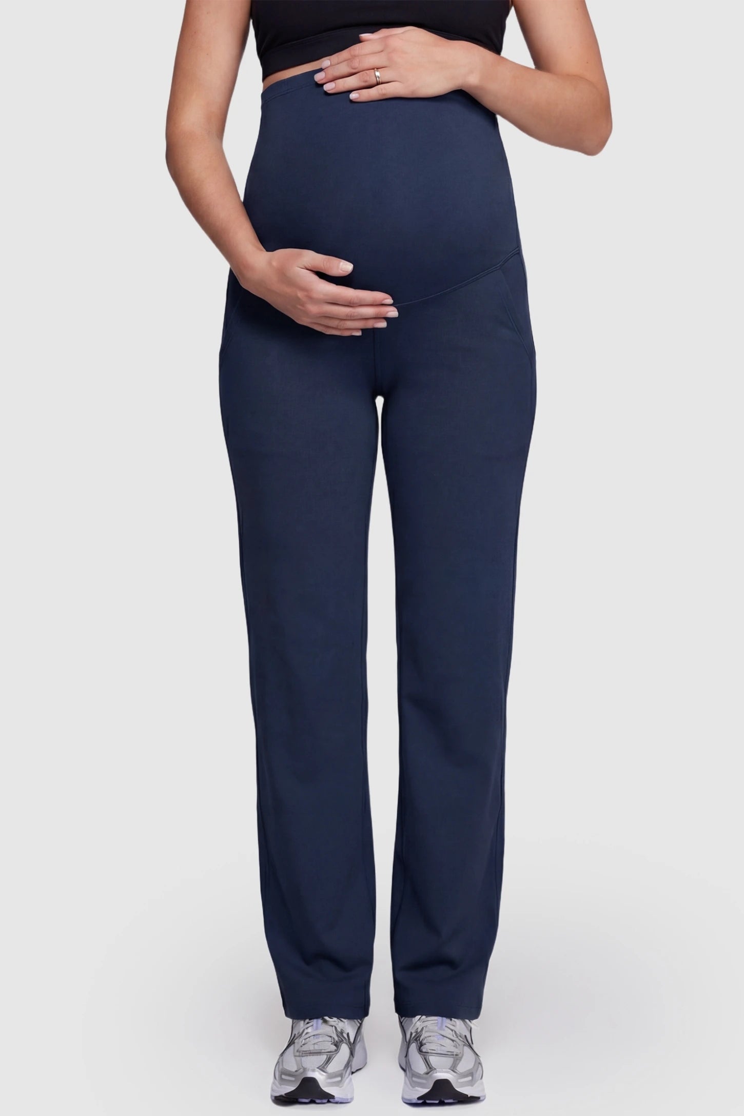 Suede-Finish High-Waisted Straight Leg Yoga Maternity Pants Suede-finish high-waisted straight leg yoga maternity pants in navy blue with belly support band, front view on pregnant model