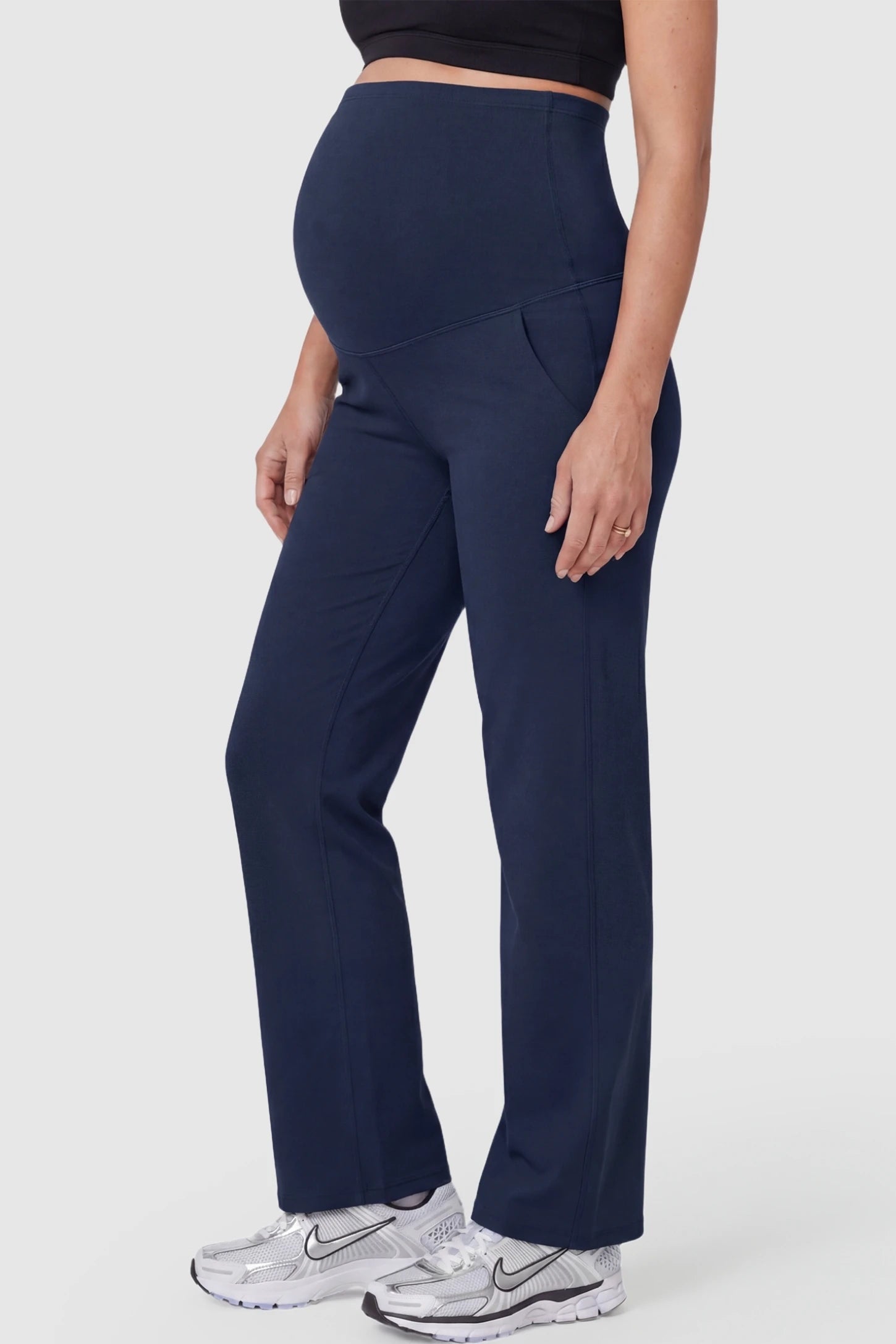 Suede-Finish High-Waisted Straight Leg Yoga Maternity Pants Suede-finish high-waisted straight leg yoga maternity pants in navy blue with zippered pockets, side view on pregnant model