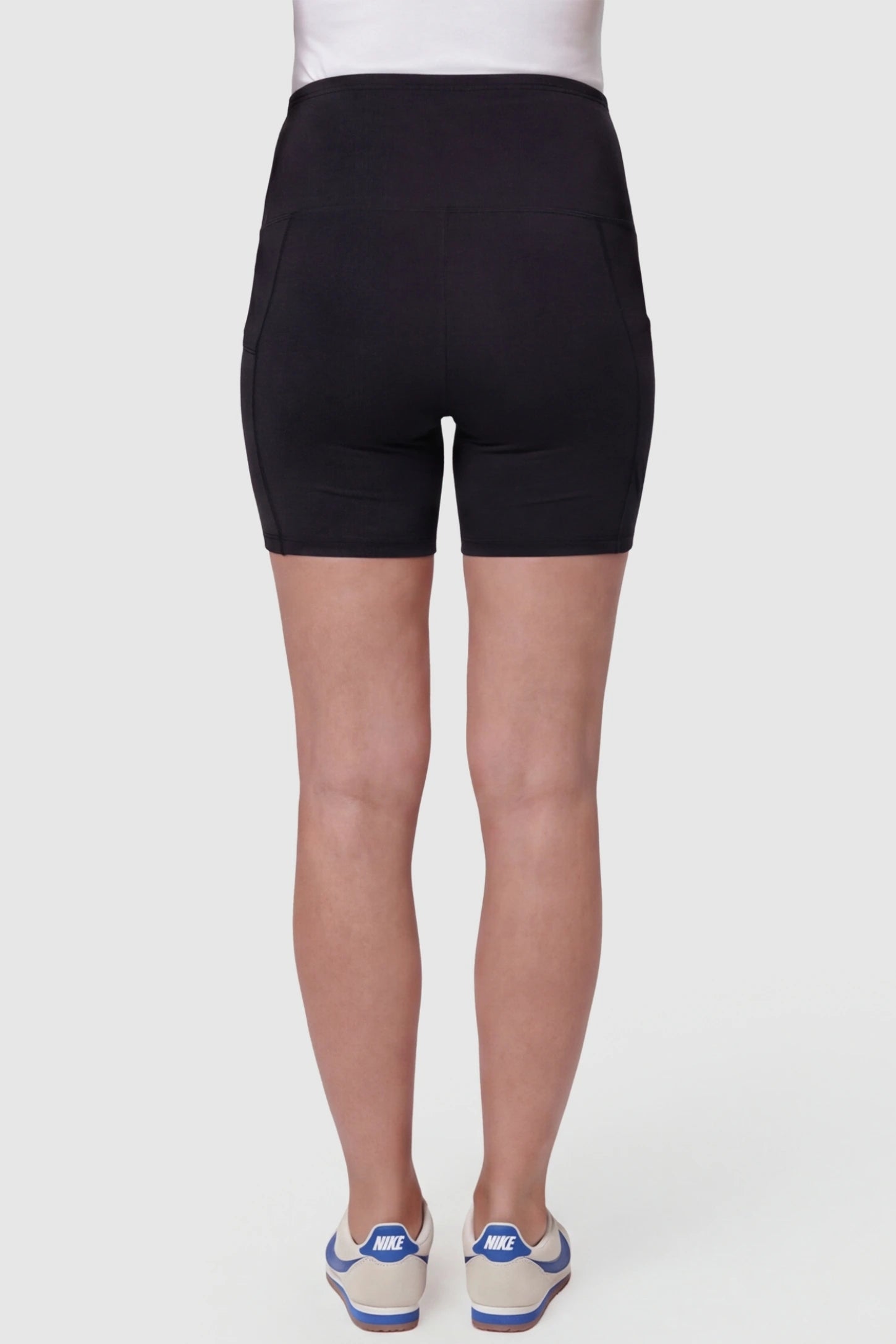 High-Waist Tummy Support Body-Hugging Maternity Shorts High-waist tummy support body-hugging maternity shorts in black with smooth rear design, back view on pregnant model