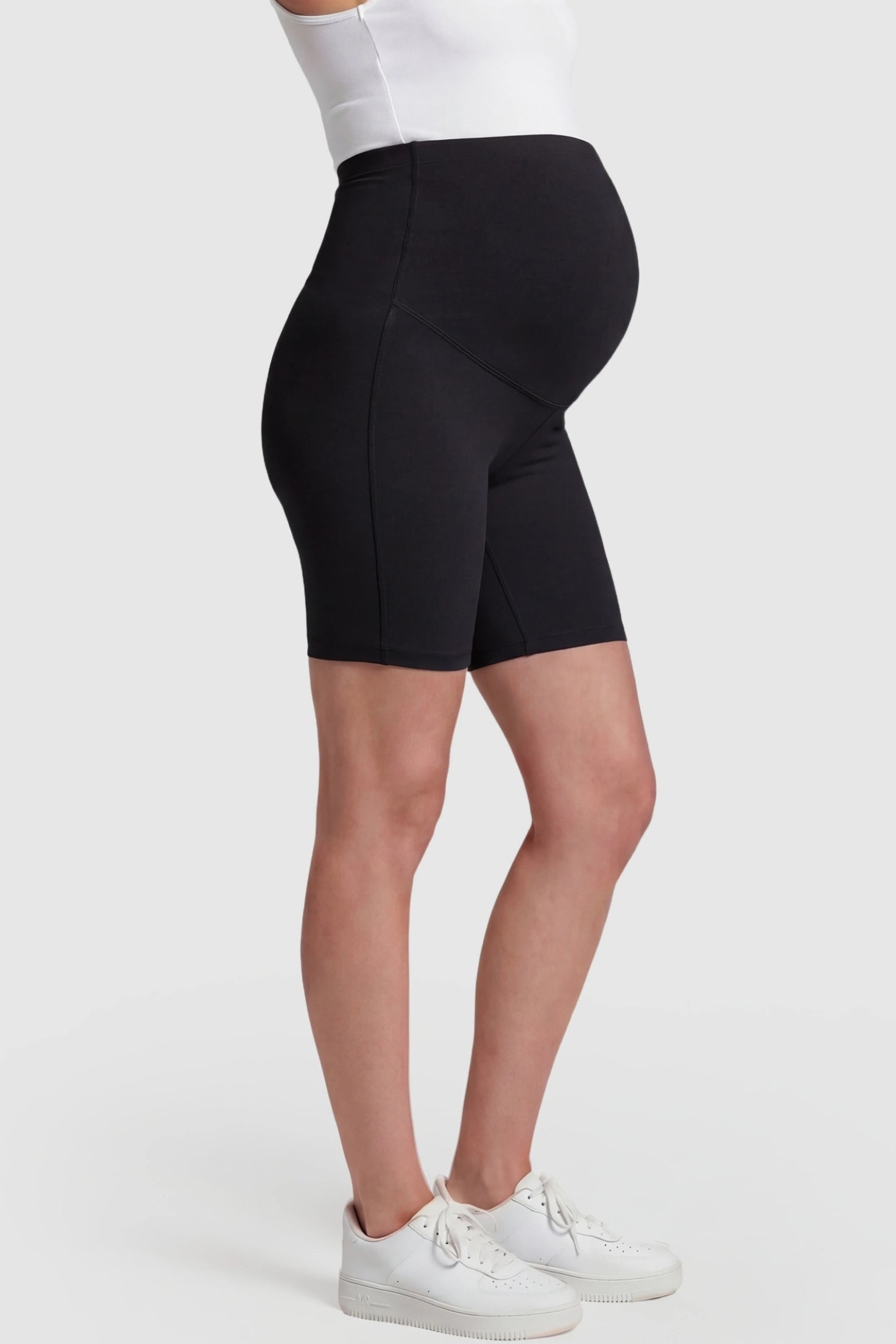 High-Waist Belly Support Slim Fit Shark Maternity Shorts High-waist belly support slim fit shark maternity shorts in black with cloud-soft stretch, side view on pregnant model