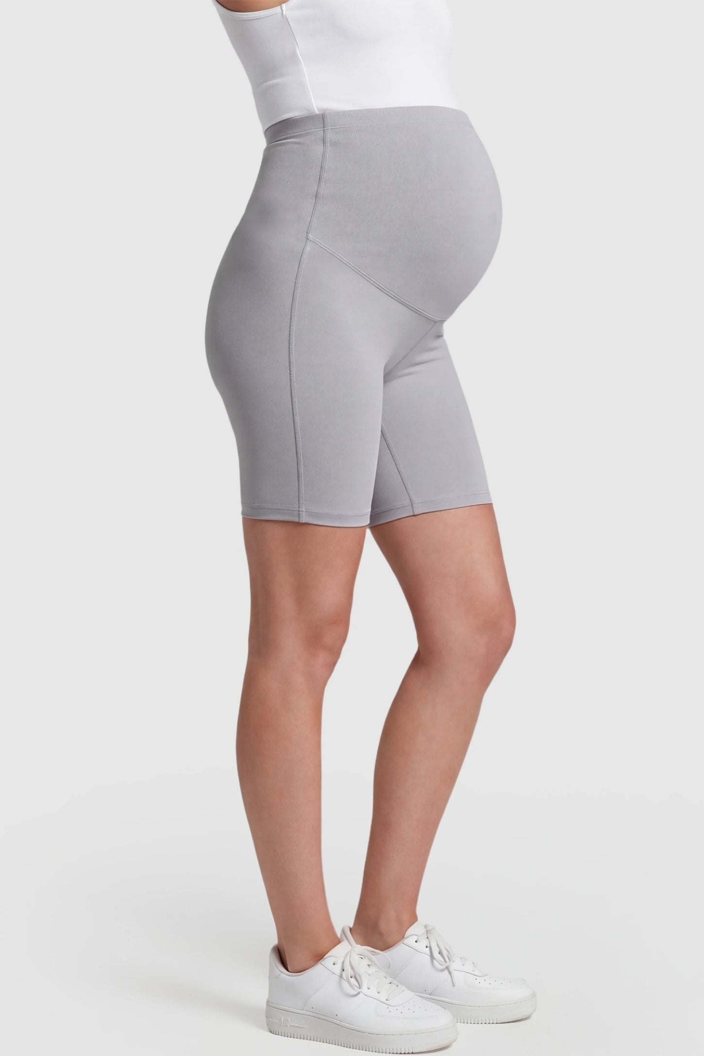 High-Waist Belly Support Slim Fit Shark Maternity Shorts High-waist belly support slim fit shark maternity shorts in light gray with cloud-soft stretch, side view on pregnant model