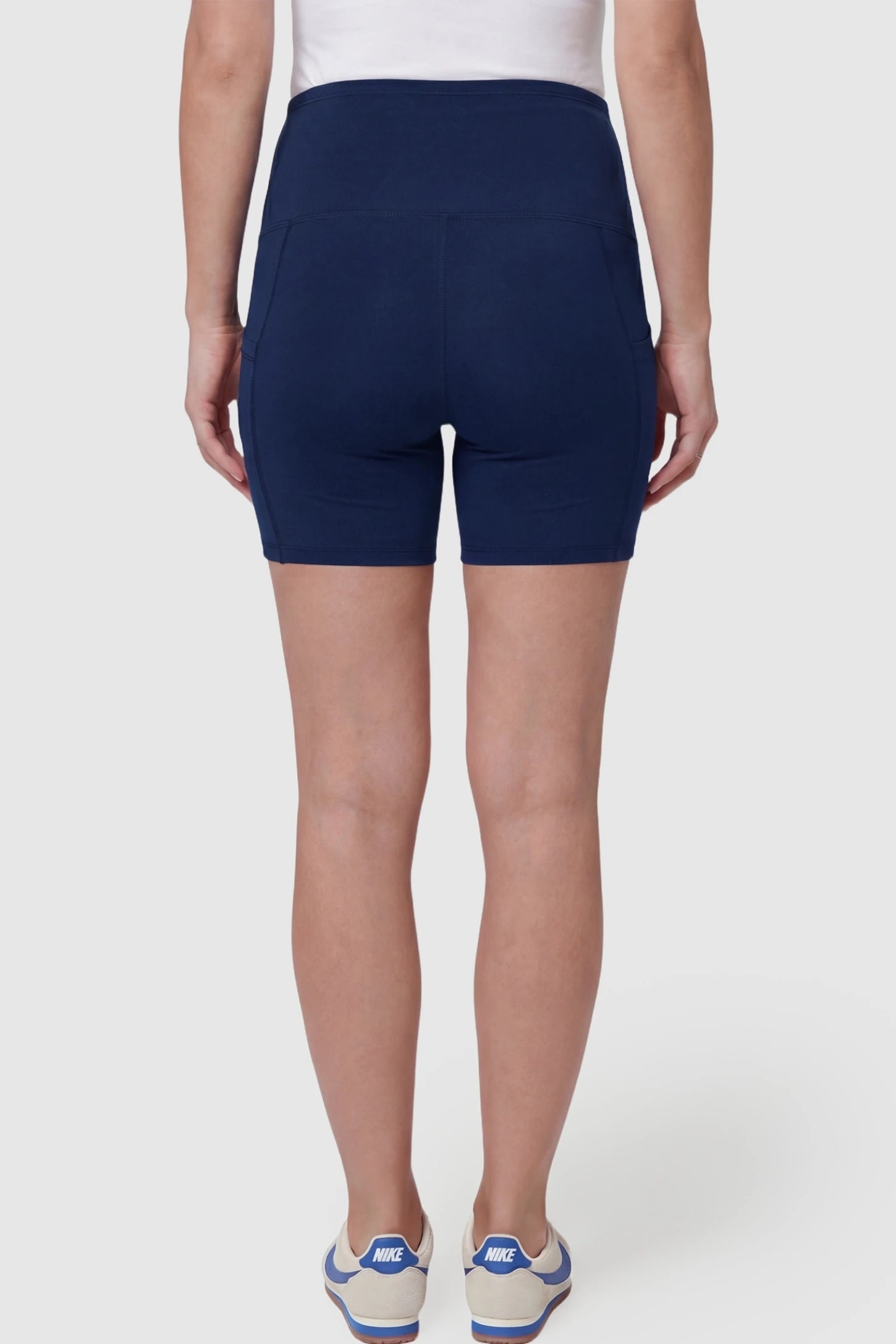 High-Waist Tummy Support Body-Hugging Maternity Shorts High-waist tummy support body-hugging maternity shorts in navy blue with smooth rear design, back view on pregnant model