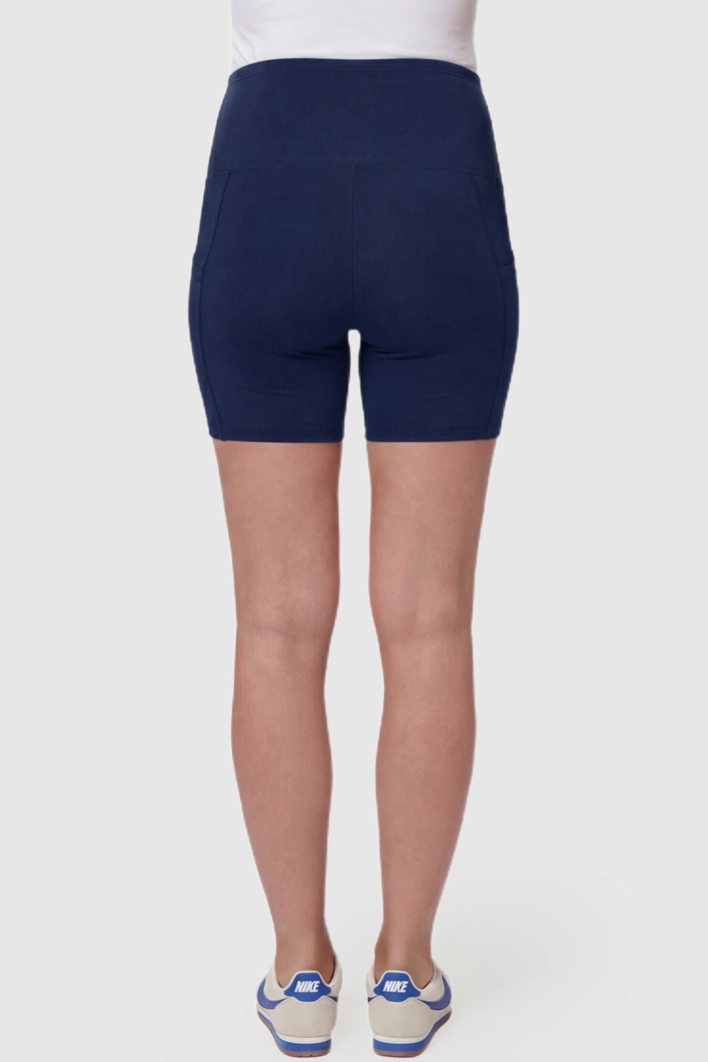 High-Waist Tummy Support Body-Hugging Maternity Shorts High-waist tummy support body-hugging maternity shorts in navy blue with smooth rear design, back view on pregnant model