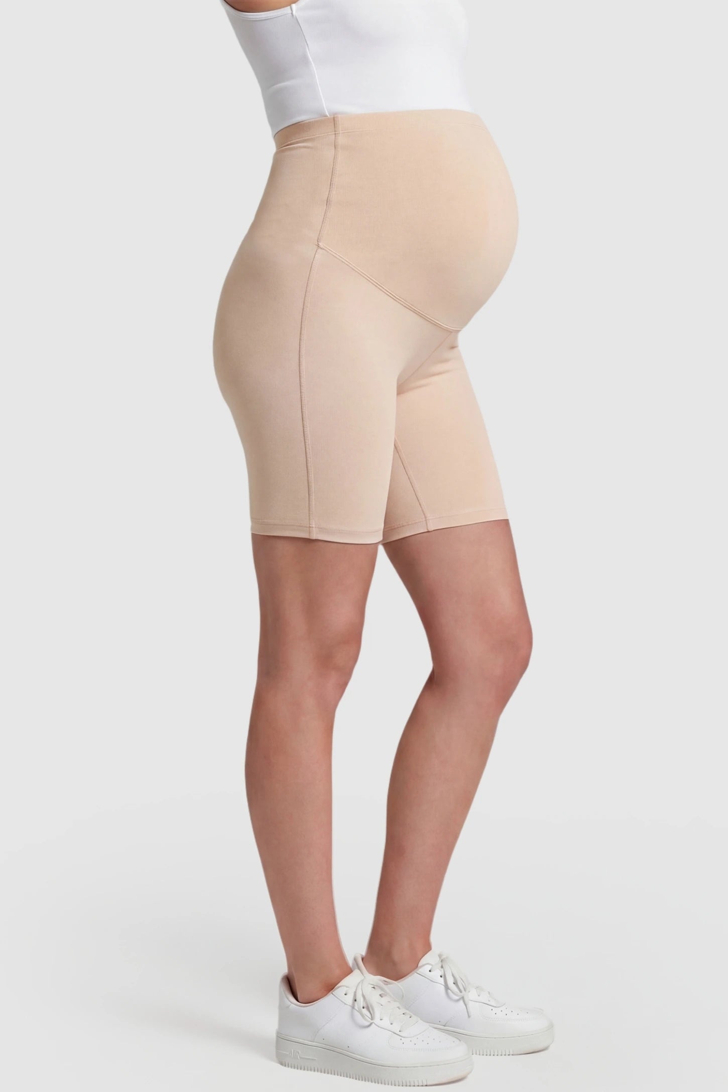 High-Waist Belly Support Slim Fit Shark Maternity Shorts High-waist belly support slim fit shark maternity shorts in skin tone with cloud-soft stretch, side view on pregnant model