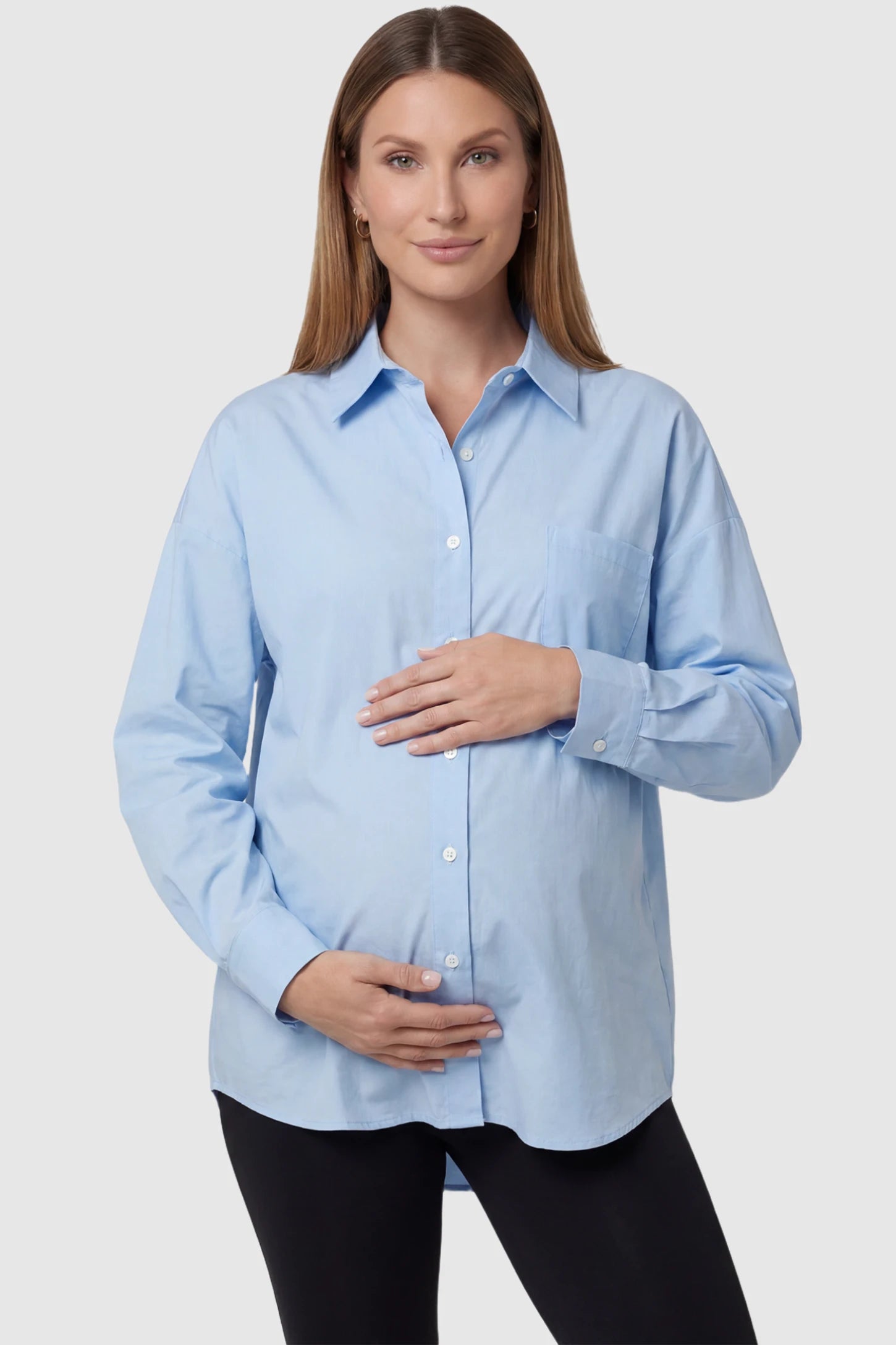 Button Down Collared Maternity Shirt in light blue featuring long sleeves and a crisp cotton finish on a pregnant model, front view.