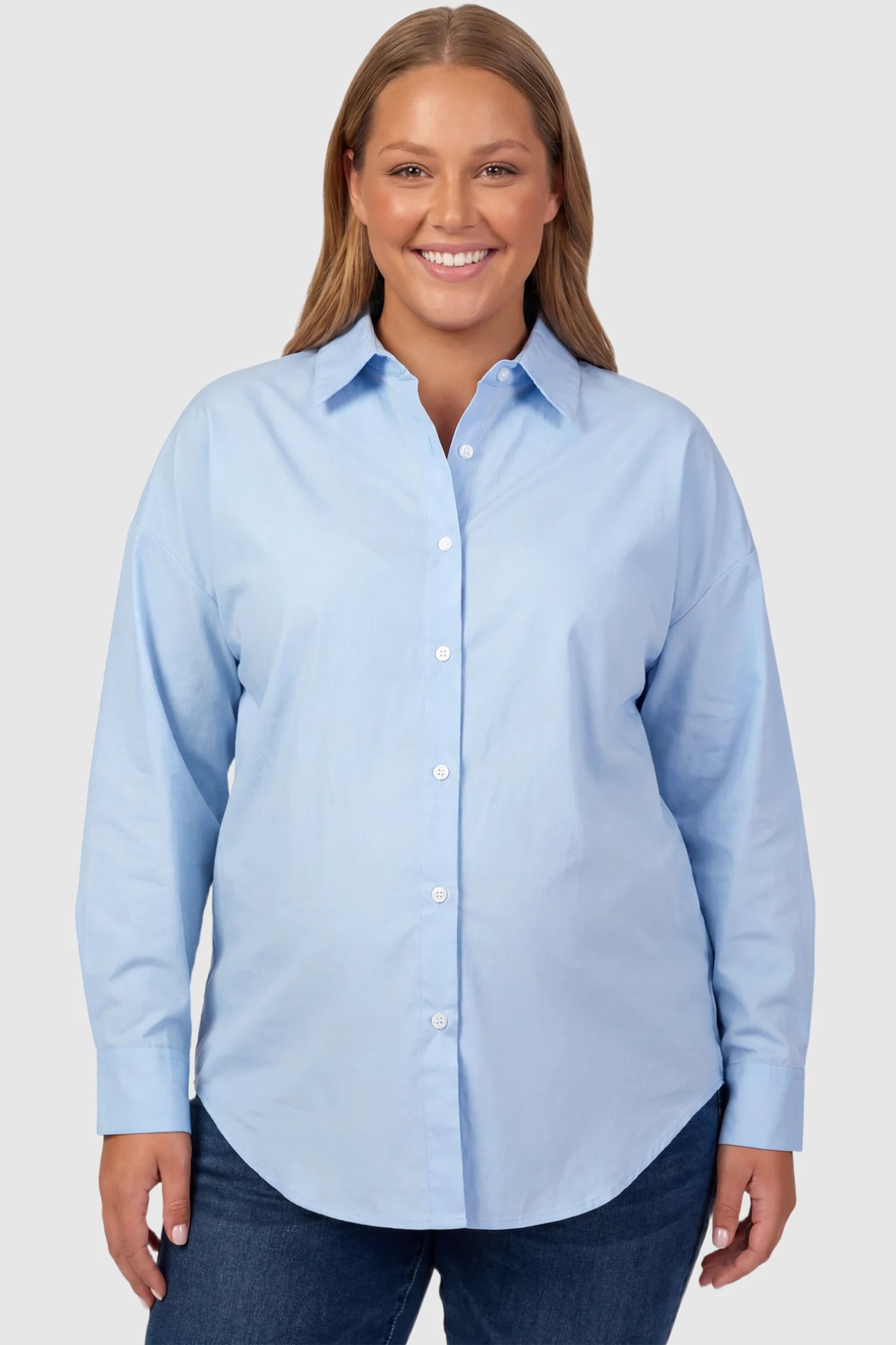 Button Down Collared Maternity Shirt Button Down Collared Maternity Shirt in light blue featuring long sleeves and a crisp cotton finish on a plus size pregnant model, front view.