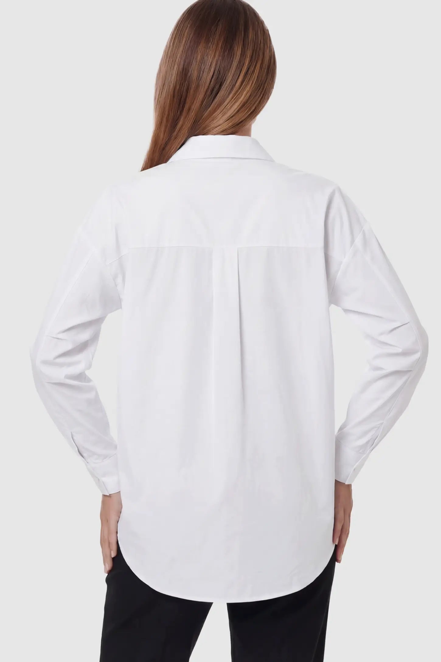 Button Down Collared Maternity Shirt Button Down Collared Maternity Shirt in white featuring long sleeves and a crisp cotton finish on a pregnant model showing back.