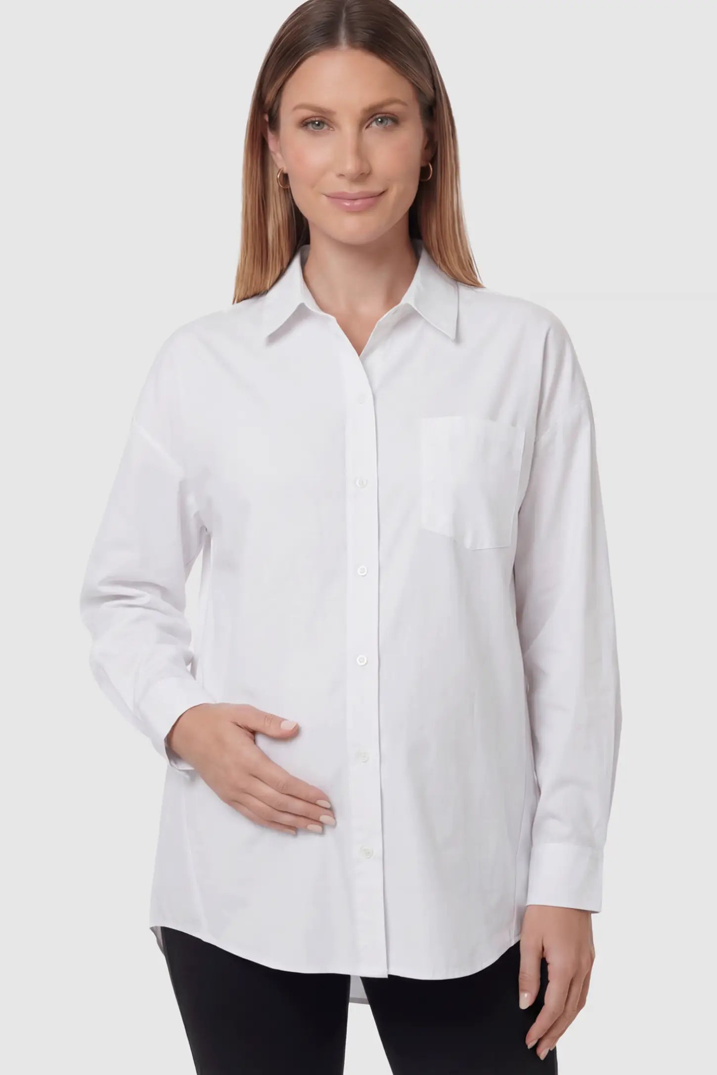 Button Down Collared Maternity Shirt Button Down Collared Maternity Shirt in white featuring long sleeves and a crisp cotton finish on a pregnant model showing front.